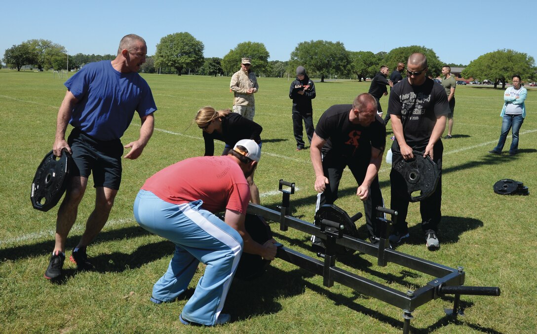 Marine Depot Maintenance Command’s team members race to add weights to a metal frame in preparation for their timed tote-n-carry competition in Marine Corps Logistics Base Albany’s Daniels Cup
Challenge at Boyett Park, April 16. MCLB Albany’s Daniels Fitness Center hosts the event each year. 