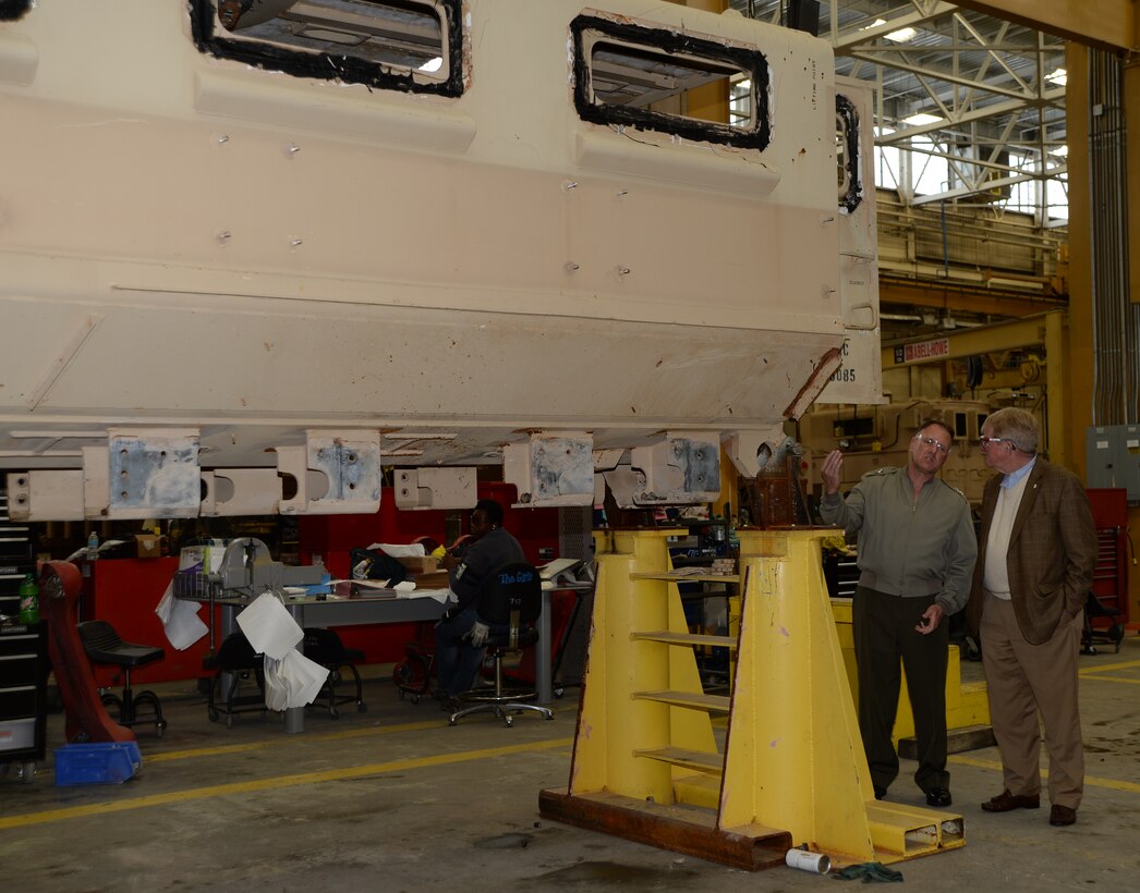 Maj. Gen. John J. Broadmeadow, commanding
general, Marine Corps Logistics Command,
describes a maintenance process to Dr. David C. Mosely, superintendent, Dougherty County
School System, during a tour of Marine Depot
Maintenance Command/Production Plant Albany,
Friday.