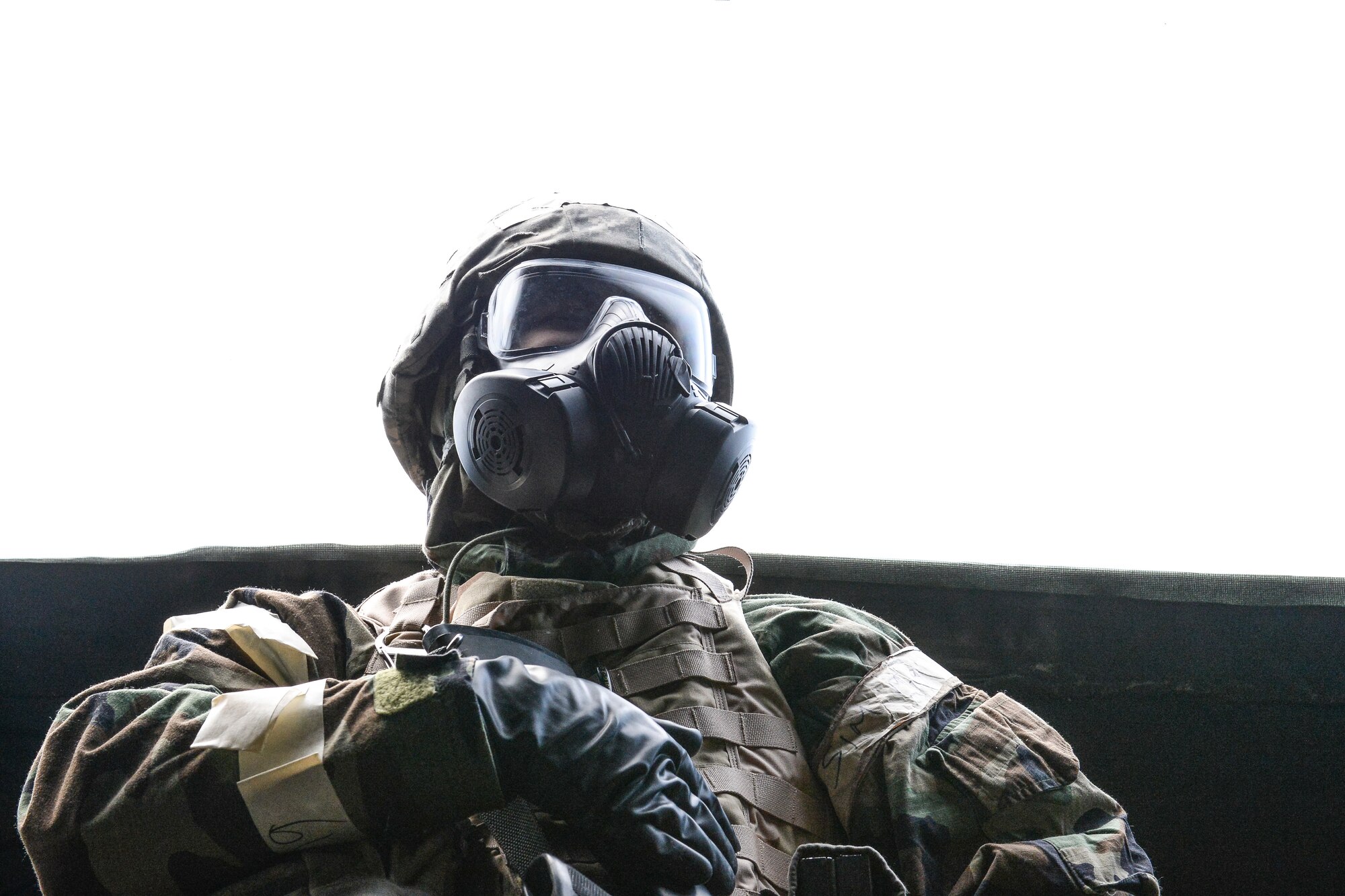 An Eielson Iceman takes a breather between simulated attacks during Ability to Survive and Operate training April 22, 2014, Eielson Air Force Base, Alaska. The field training exposes Airmen to multiple simulated enemy attacks and self-aid and buddy care scenarios to prepare them for emergency incidents at home base and abroad. (U.S. Air Force photo by Senior Airman Peter Reft/Released)