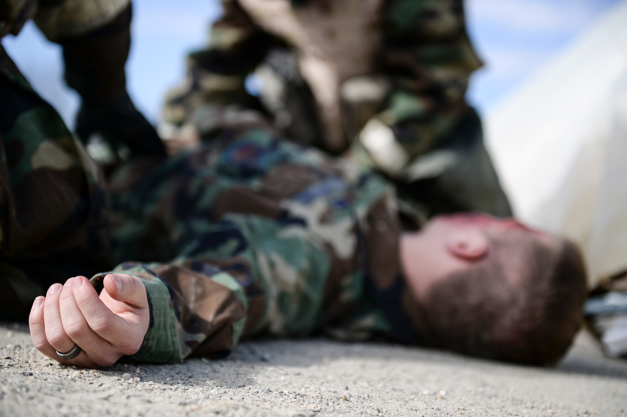 Eielson Icemen respond to a simulated casualty of a chemical attack during Ability to Survive and Operate training April 22, 2014, Eielson Air Force Base, Alaska. Participants ran through multiple self-aid and buddy care scenarios throughout the training to improve necessary skills needed to survive during enemy attacks. (U.S. Air Force photo by Senior Airman Peter Reft/Released)