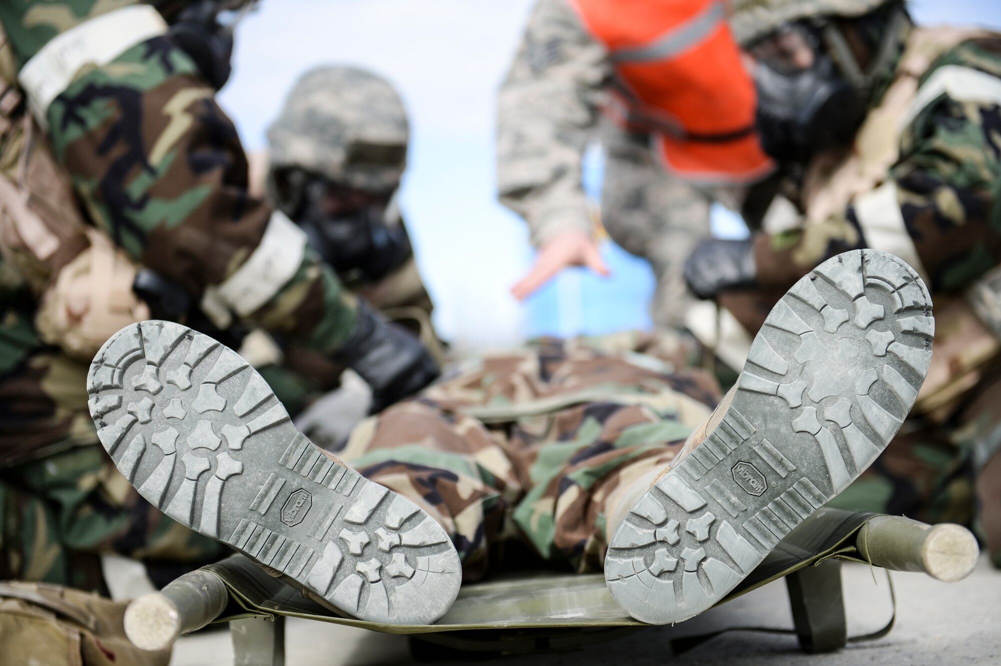 Eielson Icemen receive instruction on handling a litter with a simulated casualty during Ability to Survive and Operate training April 22, 2014, Eielson Air Force Base, Alaska. Personnel on the scene helped ATSO participants through every simulated incident to ensure proper procedures were followed. (U.S. Air Force photo by Senior Airman Peter Reft/Released)