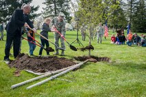Vice Adm. Norbert Ryan, Lt. Col. Jason Campbell and Col. Brian Newberry with the help of Michael Anderson Elementary School fifth graders shovel the first dirt during the annual Arbor Day celebration in Miller Park at Fairchild Air Force Base, Wash., April 25, 2014. The base celebrates 20 years as a Tree City USA. This recognizes the base for effectively managing public tree resources and to encourage the implementation of community tree management. Ryan is the Military Officers Association of America president, Campbell is the 92nd Civil Engineer Squadron commander and Newberry is the 92nd Air Refueling Wing commander. (U.S. Air Force photo by Staff Sgt. Benjamin W. Stratton/Released)