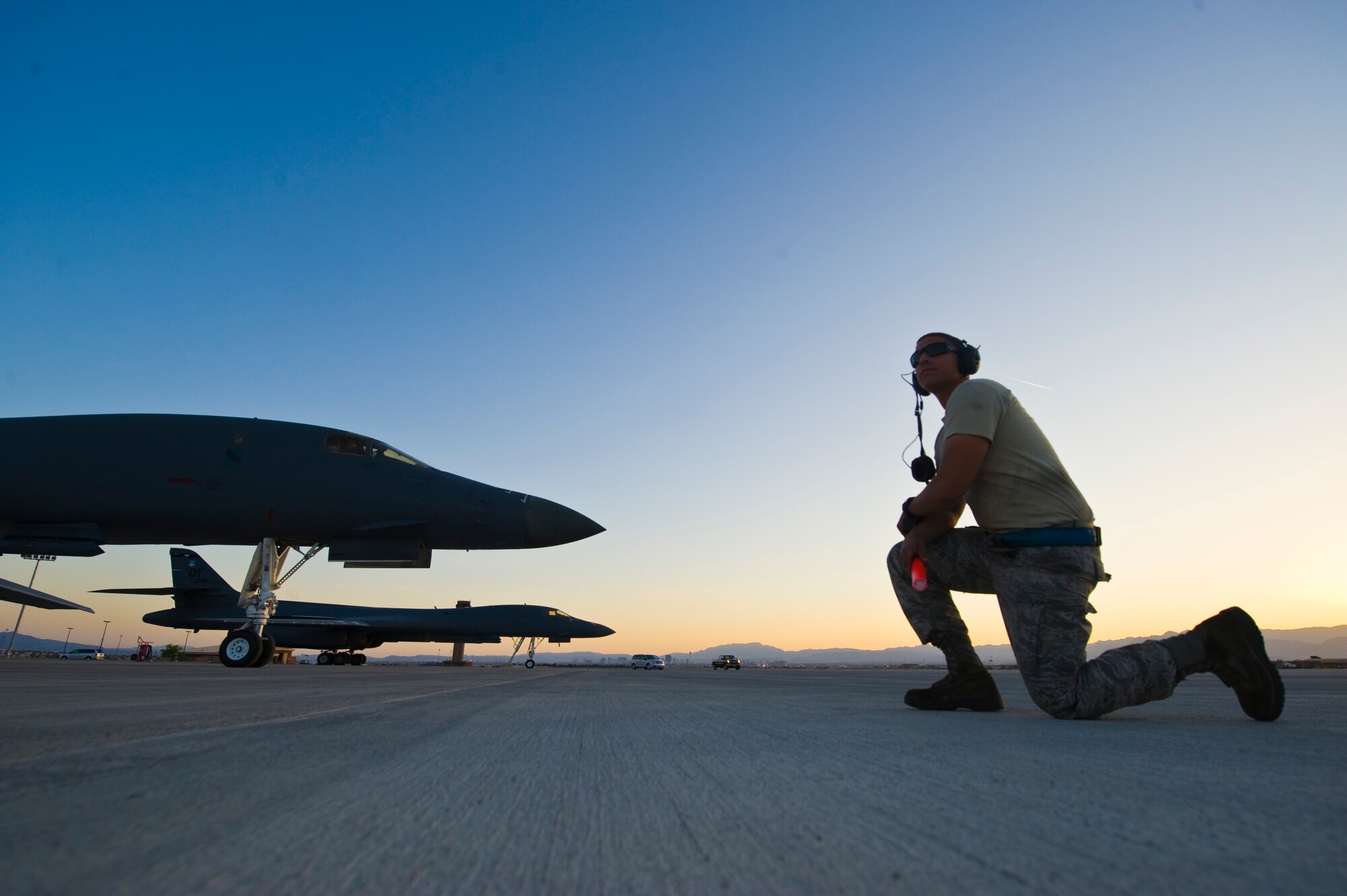 Senior Airman Ellery Lopez, 7th Aircraft Maintenance Squadron crew chief, waits to signal out a B-1B Lancer assigned to the 7th Bomb Wing, Dyess Air Force Base, Texas during Green Flag 14-6 April 24, 2014, at Nellis Air Force Base, Nev. The Green Flag exercise provides aircrew and maintainers training during simulated warfare conditions. (U.S. Air Force photo by Senior Airman Christopher Tam)