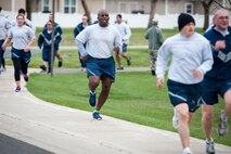 Airmen finish the 1.5 mile Sexual Assault Awareness Month road race April 25, 2014, at Fairchild Air Force Base, Wash. Participants were given the option to run either 1.5 mile or 5k races. The first 300 runners to cross the finish line were awarded a sexual assault awareness themed t-shirt. (U.S. Air Force photo by Staff Sgt. Benjamin W. Stratton/Released)