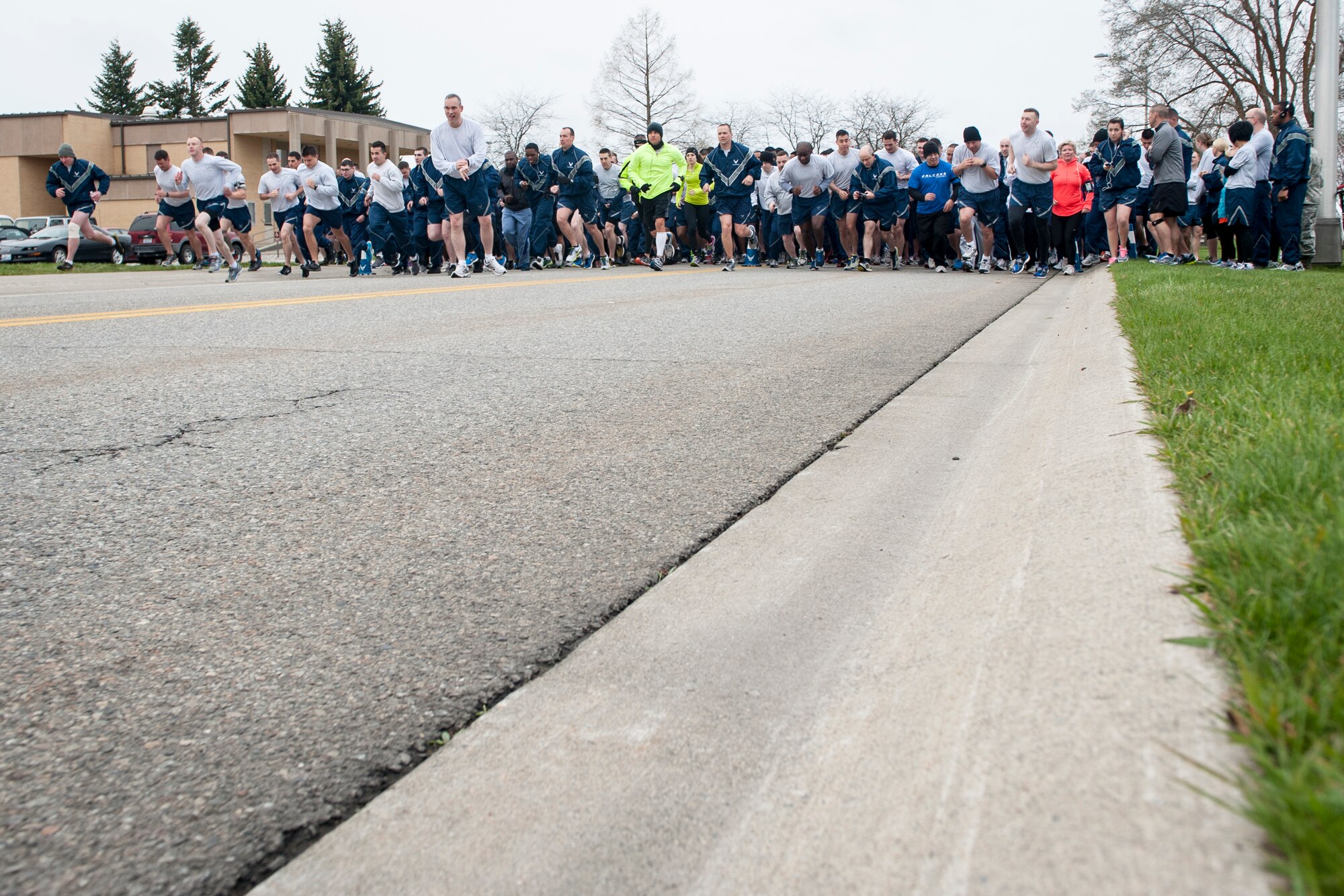 Airmen launch themselves at the start of the Sexual Assault Awareness Month road race April 25, 2014, at Fairchild Air Force Base, Wash. Participants were given the option to run either 1.5 mile or 5k races. The first 300 runners to cross the finish line were awarded a sexual assault awareness themed t-shirt. (U.S. Air Force photo by Staff Sgt. Benjamin W. Stratton/Released)