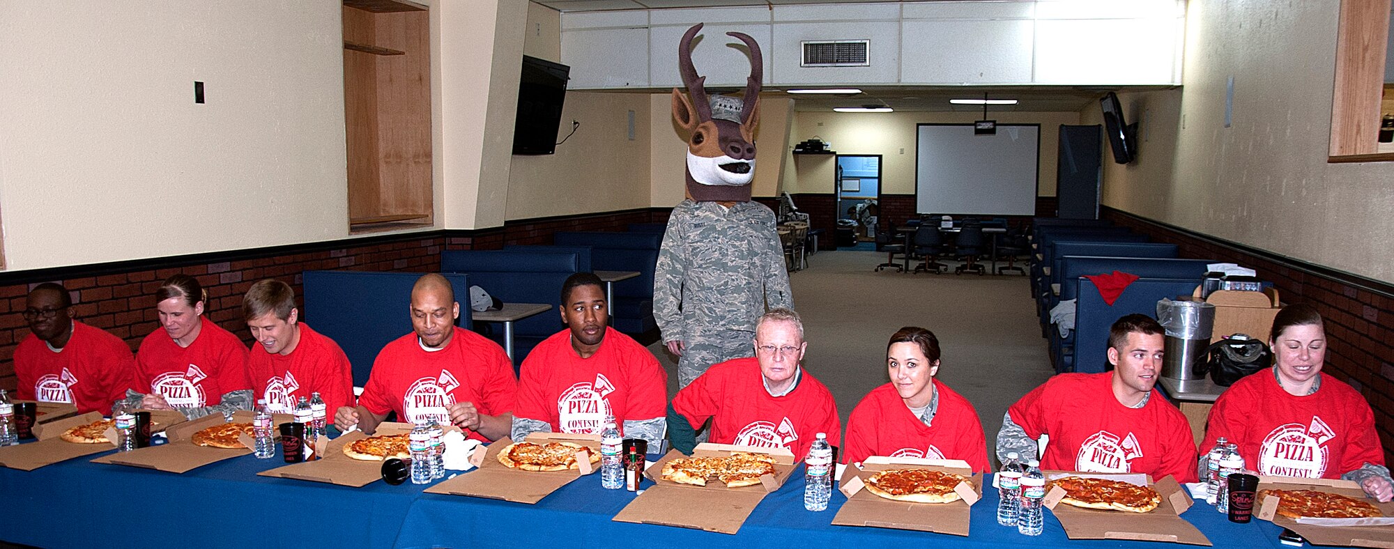 140424-F-GZ967-032 Competitors prepare to dig in during a pizza eating contest as part of the Warren Lanes Bowling Center’s Customer Appreciation Day April 24. Participants had ten minutes to try and eat an entire pizza and to win a $100 gift card. (U.S. Air Force photo by Airman 1st Class Brandon Valle)