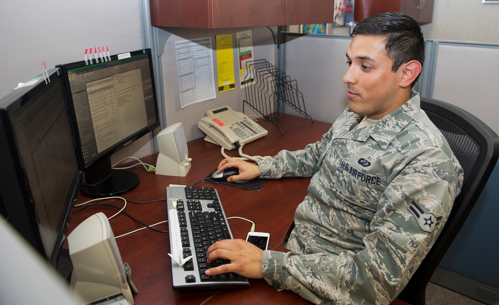 Airman 1st Class Christian Maya 22nd Contracting Squadron contract administrator, verifies the accuracy of an invoice, April 18, 2014, McConnell Air Force Base, Kan. Maya was selected as the spotlight performer for the week of April 21 through 25. (U.S. Air Force photo/Airman 1st Class Colby Hardin)