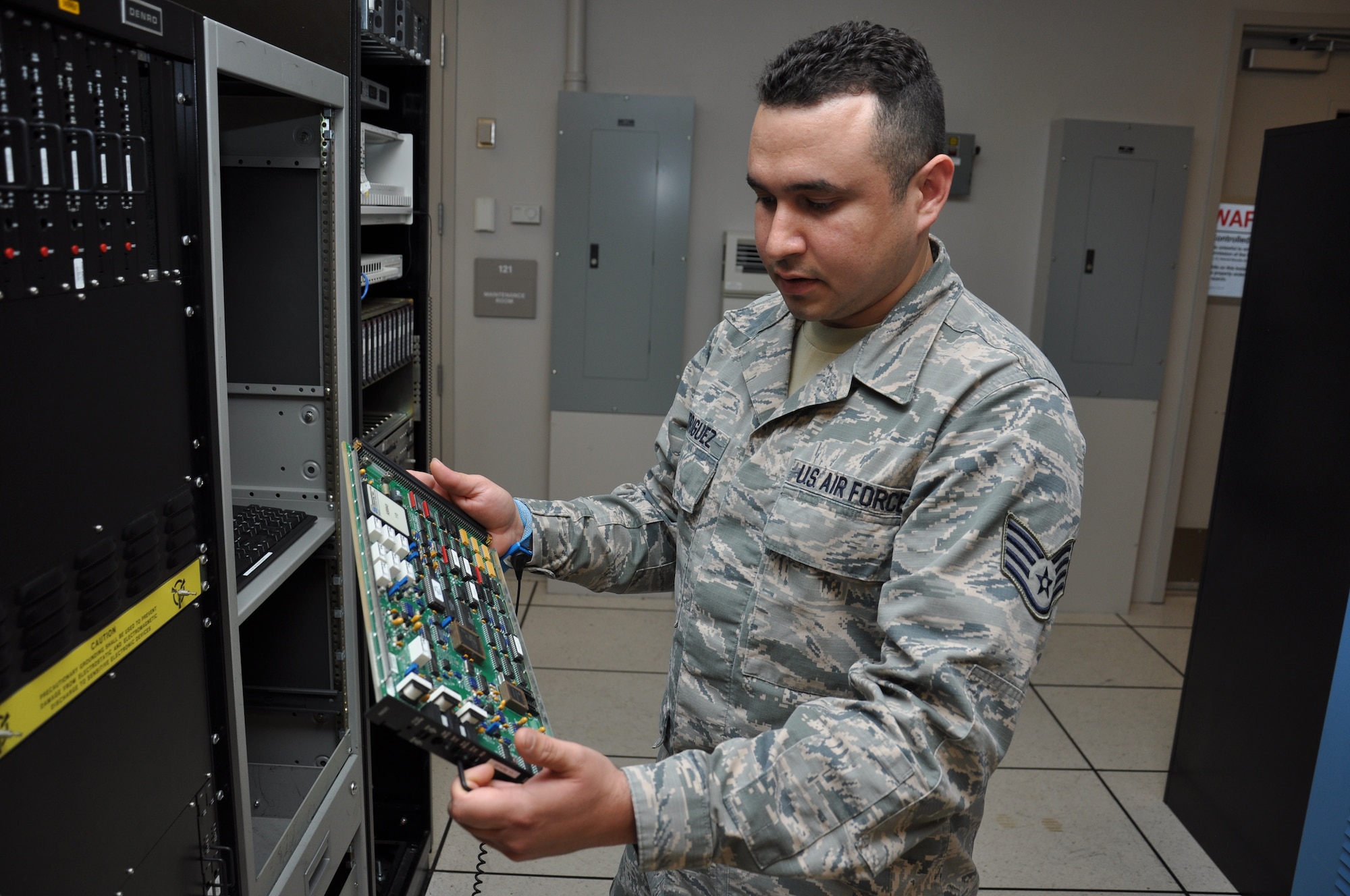 Staff Sgt. Richard Rodriguez-Marquez, 60th Communications Squadron airfield systems technician, examines a circuit board April 23, 2014, at Travis Air Force Base, Calif. (U.S. Air Force photo by Staff Sgt. Christopher Carranza)