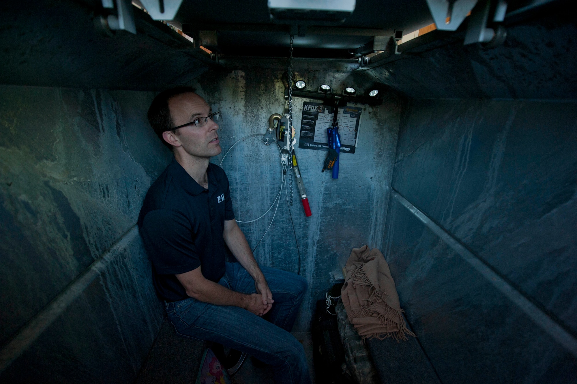 Jeremy Kirk, 82nd Civil Engineering Squadron emergency management specialist, sits down in the tornado shelter at his house April 23, 2014. Kirk helps the 82nd CES formulate escape and preparation plans for natural disasters. (U.S. Air Force photo by Airman 1st Class Jelani Gibson)