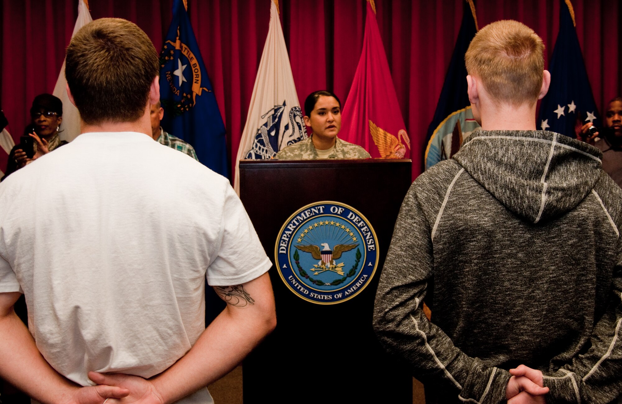 Two military applicants partake in the Oath of Enlistment April 1, 2014, at the Sacramento Military Entry Processing Station. Upon enlisting in the U.S. armed forces, each person whether a Soldier, Sailor, Coast Guardsman, Airman or Marine takes an Oath of Enlistment. (U.S. Air Force photo by Senior Airman Charles V. Rivezzo)