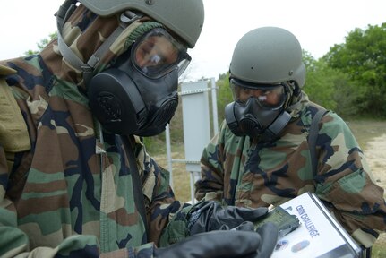 U.S. Air Force Senior Airman Jeffery Smith left and Technical Sgt. Akira Matsumura, 559th Aerospace Medicine Squadron, Joint Base San Antonio-Lackland, take a chemical release test, after a simulated missile attack April 24, 2014 at Joint Base San Antonio-Randolph. (U.S. Air Force photo by Joel Martinez)