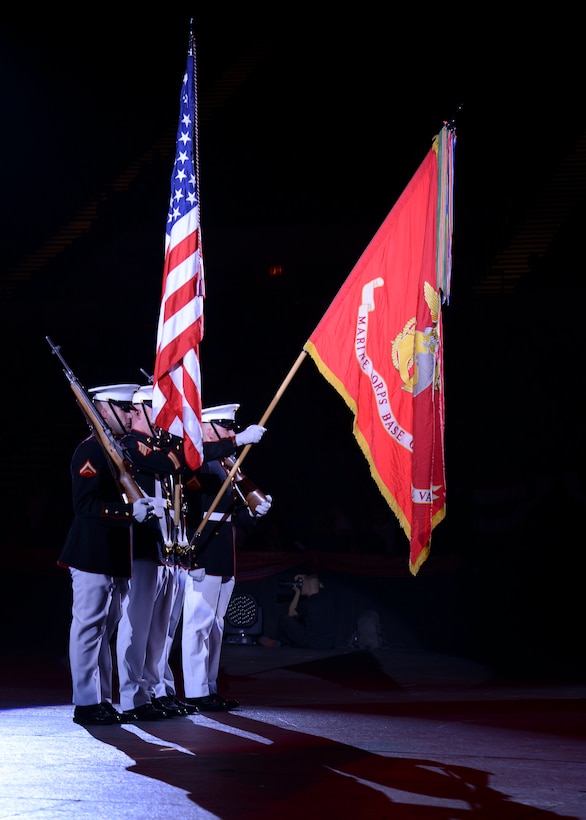 The U.S. Marine Corps Honor Guard performs during the Virginia International Tattoo, Virginia Art Festival, at the Scope Arena in Norfolk, Va., April 23, 2014.  Tattoos are ceremonial performances of military music by massed bands and have been practiced since the 17th century. (U.S. Air Force photo by Airman 1st Class Devin Scott Michaels/Released)(This image was cropped to emphasize the subject. Medium burning was done to objects in background to emphasize subject)