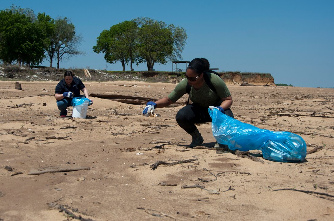 Rebecca Gorman, 82nd Civil Engineering Squadron (left), and Airman 1st Class Alycia Bowman, 80th Operations Support Squadron (right), pick up litter and debris along the shoreline of Lake Texoma, April 22, 2014. Gorman and Bowman were two of 11 volunteers from Sheppard Air Force Base, Texas, who participated in an Earth Day clean-up event geared toward ridding the beach of hazardous objects and litter exposed by the low water levels. (U.S. Air Force photo/Airman 1st Class Robert L. McIlrath)