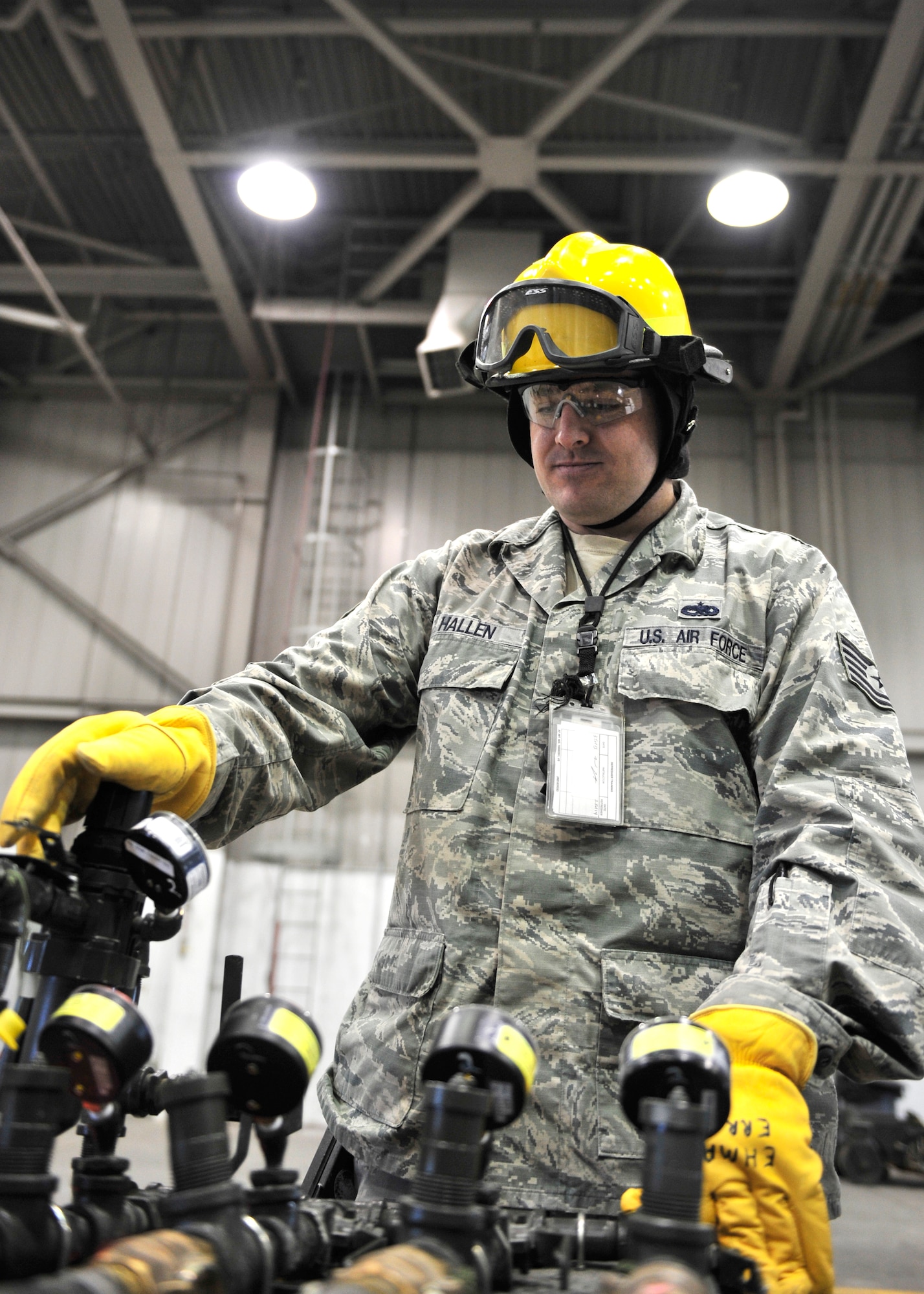 Tech Sgt. Jason Hallen, 354th Maintenance Squadron crash recovery section chief, broadens a manifold to allow for more air flow during an exercise scenario April 23, 2014, Eielson Air Force Base, Alaska. The air expanded bags that lifted an aircraft after a simulated aircraft emergency during an operational readiness exercise. (U.S. Air Force photo by Senior Airman Ashley Nicole Taylor/Released)