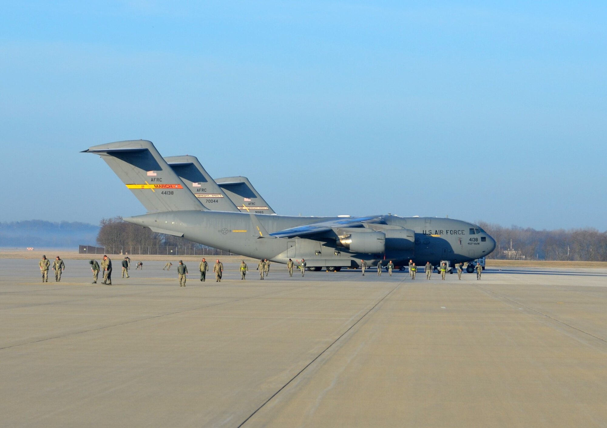 WRIGHT-PATTERSON AIR FORCE BASE, Ohio – C-17 Globemaster IIIs provide a backdrop for Airman from the 445th Airlift Wing looking for debris during the unit’s FOD walk held during the April 6 unit training assembly. (U.S. Air Force photo/Maj. Demetrius Smith)