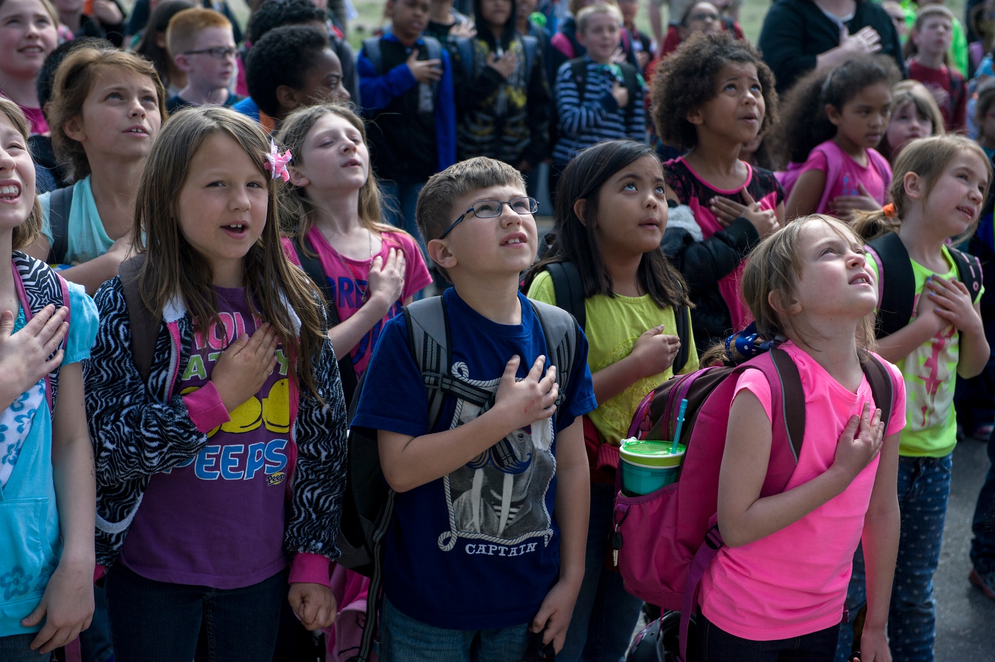 Children from the Base Primary School recite the Pledge of Allegiance, April 23, 2014, at Mountain Home Air Force Base, Idaho. Children gathered to watch as the flag was raised on their brand new flag pole. (U.S. Air Force photo by Airman 1st Class Brittany A. Chase/Released)