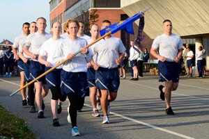 U.S. Air Force Master Sgt. Rachel Singletary, 83rd Network Operations Squadron first sergeant leads a formation Airmen from the 83rd NOS during a memorial run at Langley Air Force Base, Virginia, April 25, 2014. The Major Ransom Memorial run is held annually to honor the NATC-A NINE.  (U.S. Air Force Staff Sgt. Antoinette Gibson/Released)