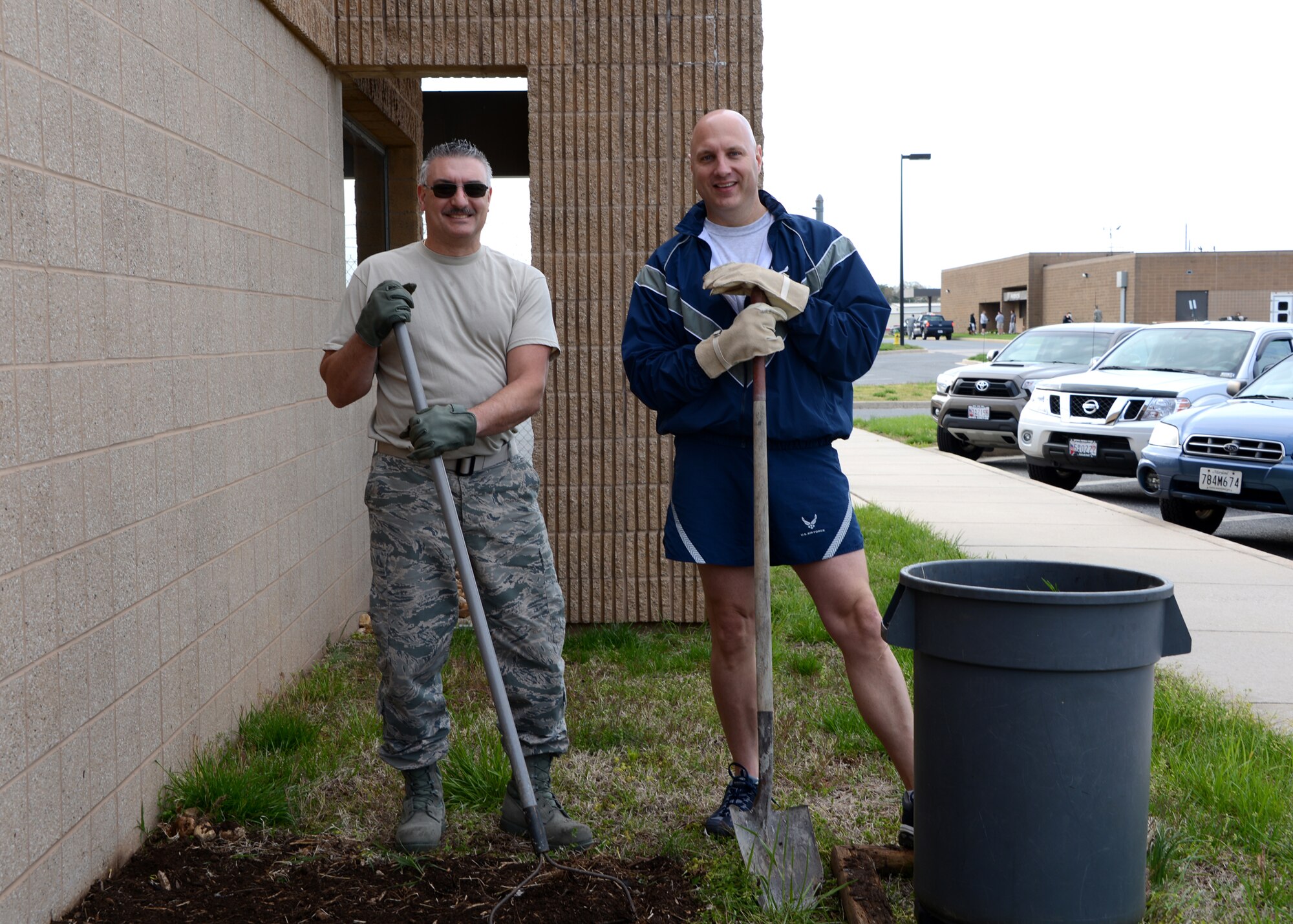 U.S. Air Force Senior Master Sgt. Doug Smith (left), 175th Logistics Readiness Squadron, and Maj. Robert Conover, 175th Logistics Readiness Squadron, take a break from mulching one of the many gardens at Warfield Air National Guard Base, Baltimore, Md., during Base Beautification Day, April 25, 2014. Base Beautification Day gives members of the 175th Wing the opportunity to improve the cleanliness and aesthetics of their outside work areas.  (U.S. Air National Guard photo by Tech. Sgt. Chris Schepers/RELEASED)