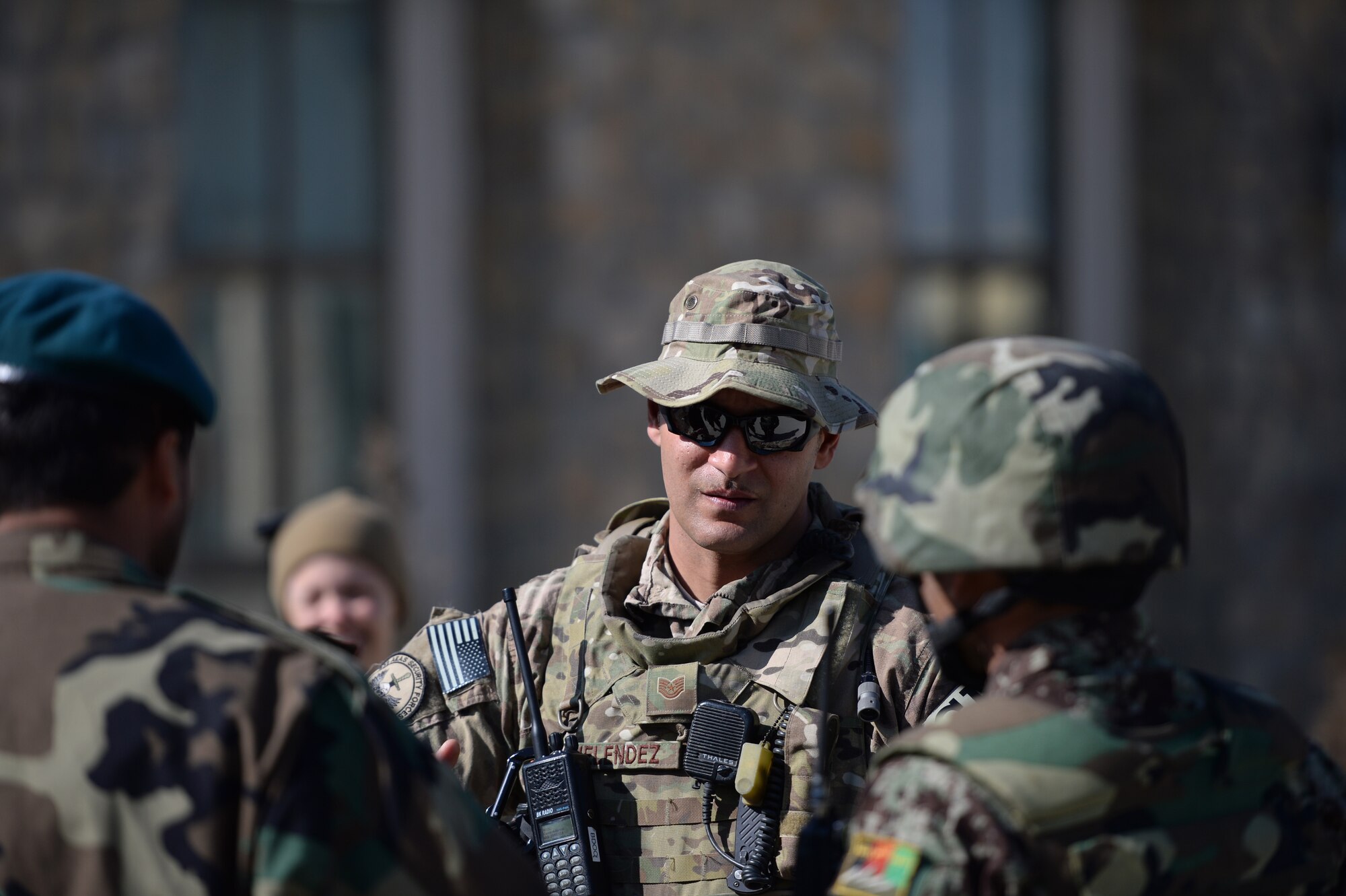 U.S. Air Force Tech. Sgt. Rafael Melendez, 438th Air Expeditionary Wing law enforcement advisor, debriefs Afghan Air Force airmen following an Unexploded Explosive Ordnance training exercise Feb. 13, 2014 in Kabul, Afghanistan. Security Forces advisory Airmen oversaw the exercise to help advise Afghan air force quick reaction forces on how to respond to possible UXO scenarios. Melendez a San Antonio, Texas, native is deployed from the 78th Security Forces Squadron, Robbins Air Force Base, Ga. (U.S. Air Force photo by Tech. Sgt. Jason Robertson/Released)