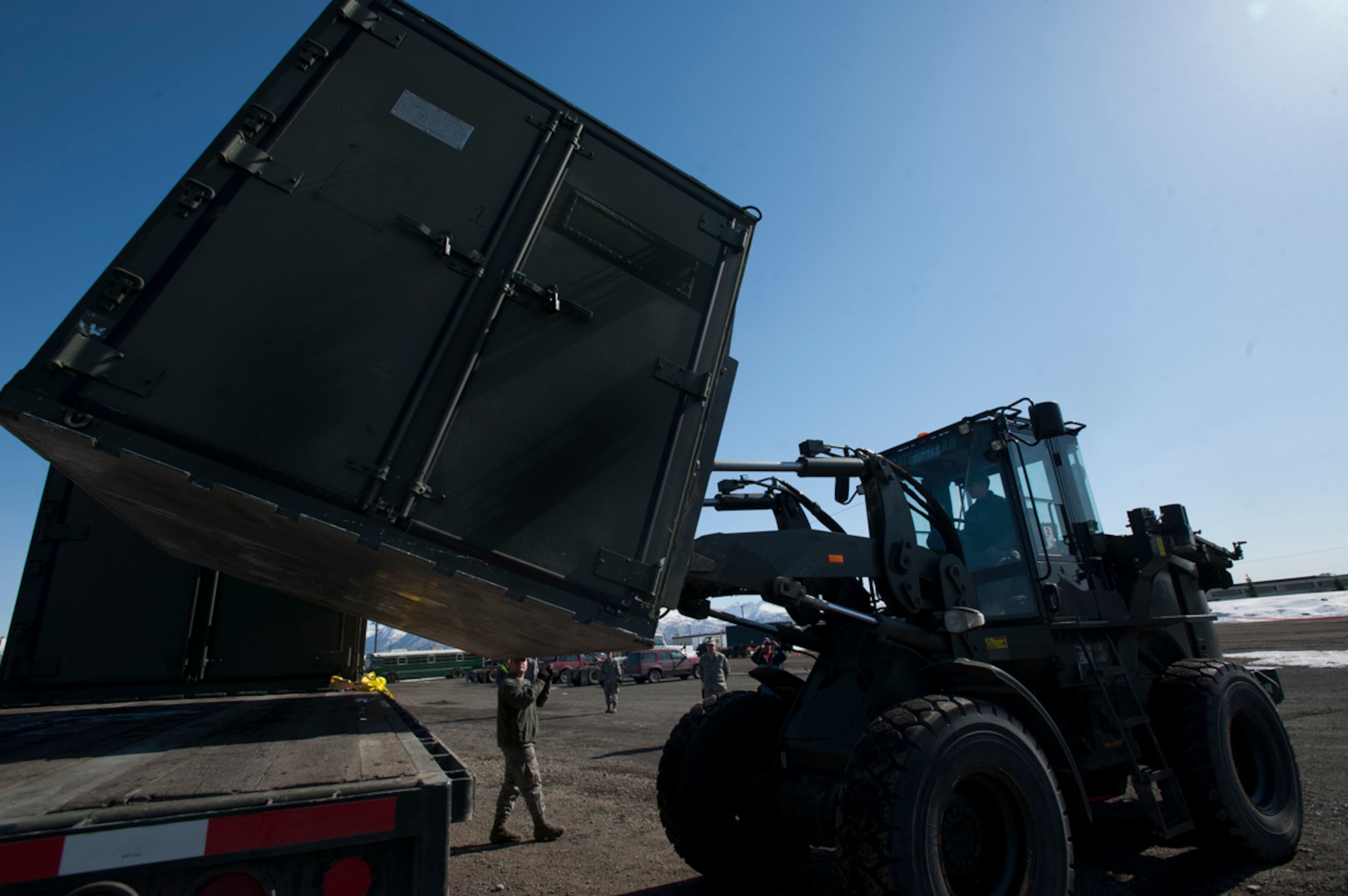 Members of the 773d Logistics Readiness Squadron Vehicle Operations move cargo on Joint Base Elmendorf-Richardson, Alaska, April 14, 2014. Vehicle Operations merged with the Army???s Transportation Motor Pool to improve mission efficiency. (U.S. Air Force photo/Staff Sgt. Robert Barnett)