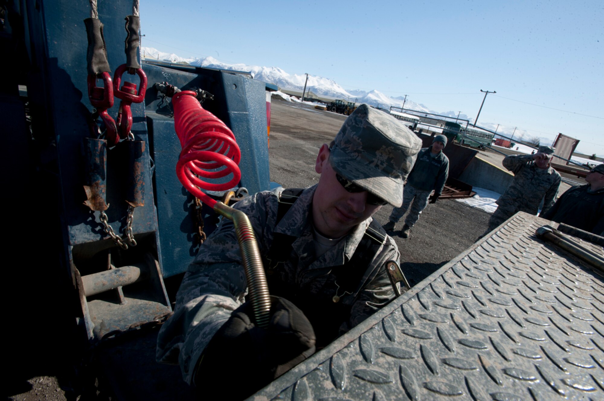Airman 1st Class Robert Eddy secures connectors on a 15-ton wrecker on Joint Base Elmendorf-Richardson, Alaska, April 14, 2014. Eddy is a 773d Logistics Readiness Squadron vehicle operator and a native of Florence, Ala. (U.S. Air Force photo/Staff Sgt. Robert Barnett)