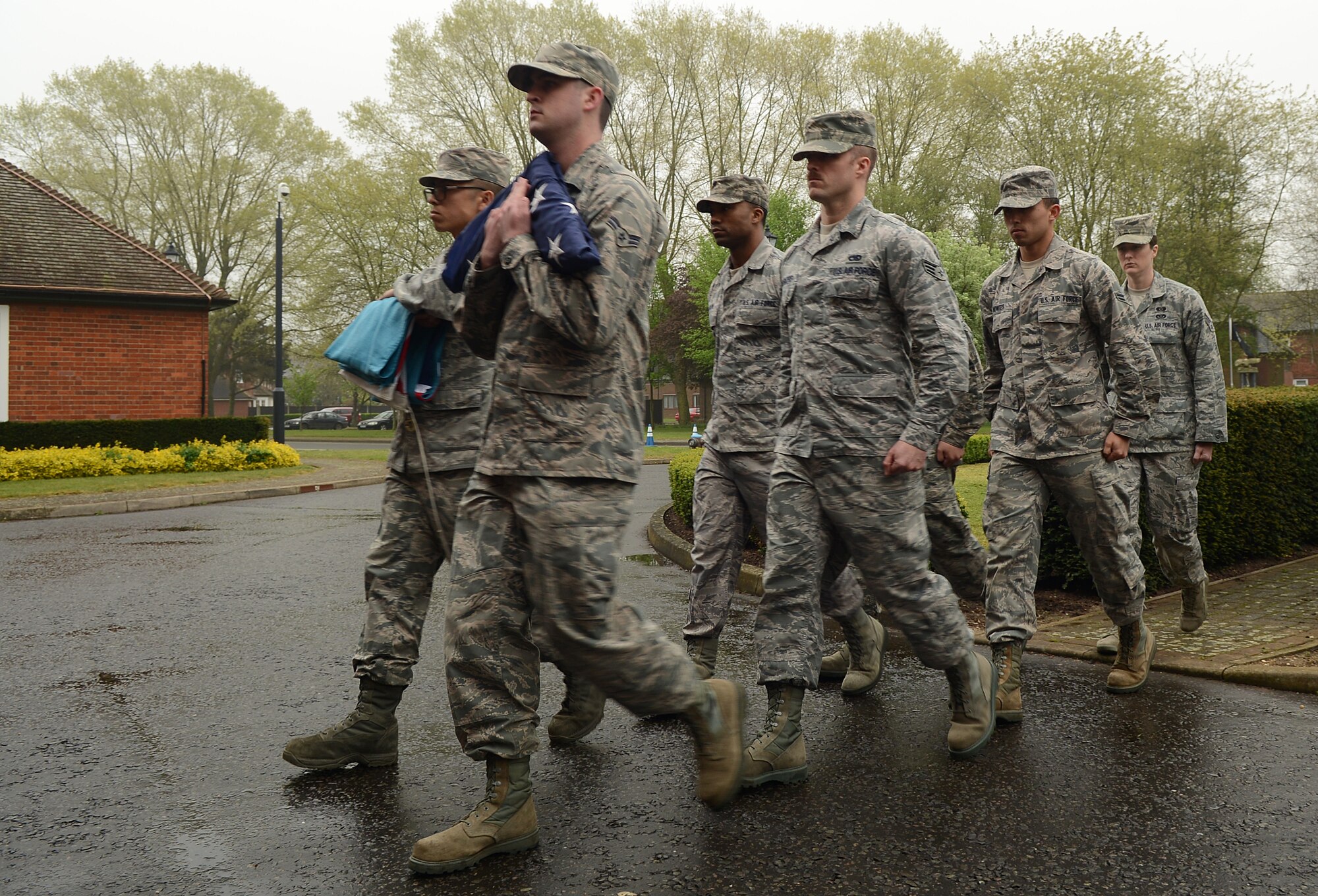 Members of a Team Mildenhall flag detail retire the U.S. flag and Royal Air Force ensign during a retreat ceremony April 25, 2014, on RAF Mildenhall, England. A retreat ceremony, in which the honor guard retires the U.S. flag and RAF ensign, is scheduled to take place on the last Friday of every month. (U.S. Air Force photo by Airman 1st Class Jonathan Light/Released)