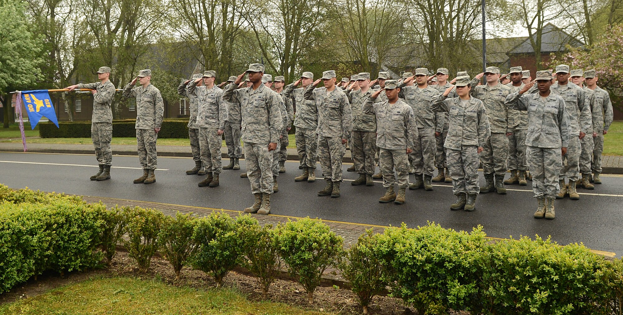 Team Mildenhall formation salutes the U.S. flag as it’s lowered during the monthly retreat ceremony April 25, 2014, on RAF Mildenhall, England. Retreat is a long-standing tradition honoring the flag and indicating the end of the duty day. (U.S. Air Force photo by Airman 1st Class Jonathan Light/Released)