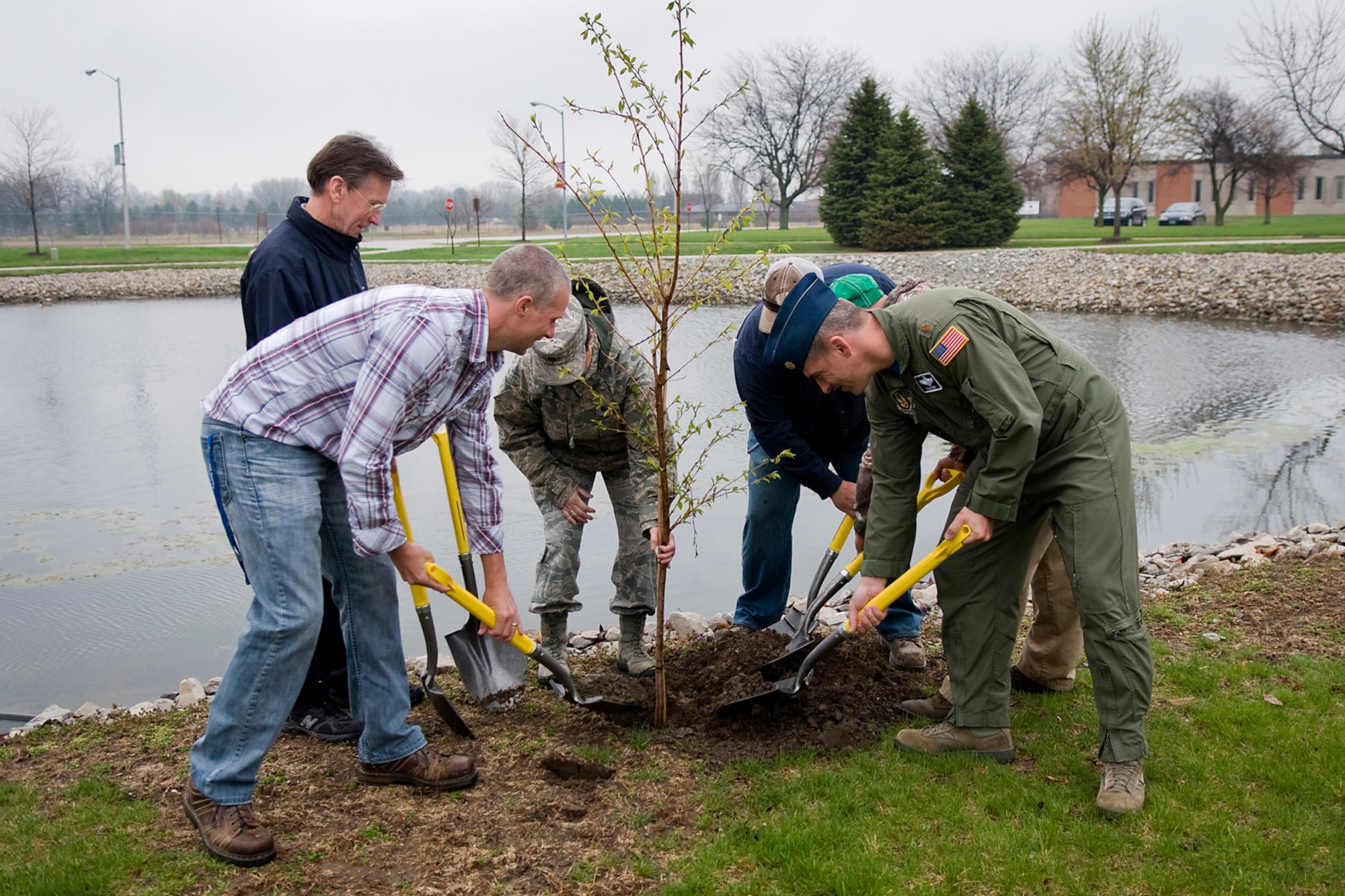 Base engineers, leadership and contractors plant a Japanese flowering Yoshino cherry tree during an Arbor Day ceremony held at Grissom Air Reserve Base, Ind., April 25, 2014. During the last Friday of each April, Grissom joins with other communities around Indiana to celebrate the day. (U.S. Air Force photo/Tech. Sgt. Mark R. W. Orders-Woempner) 