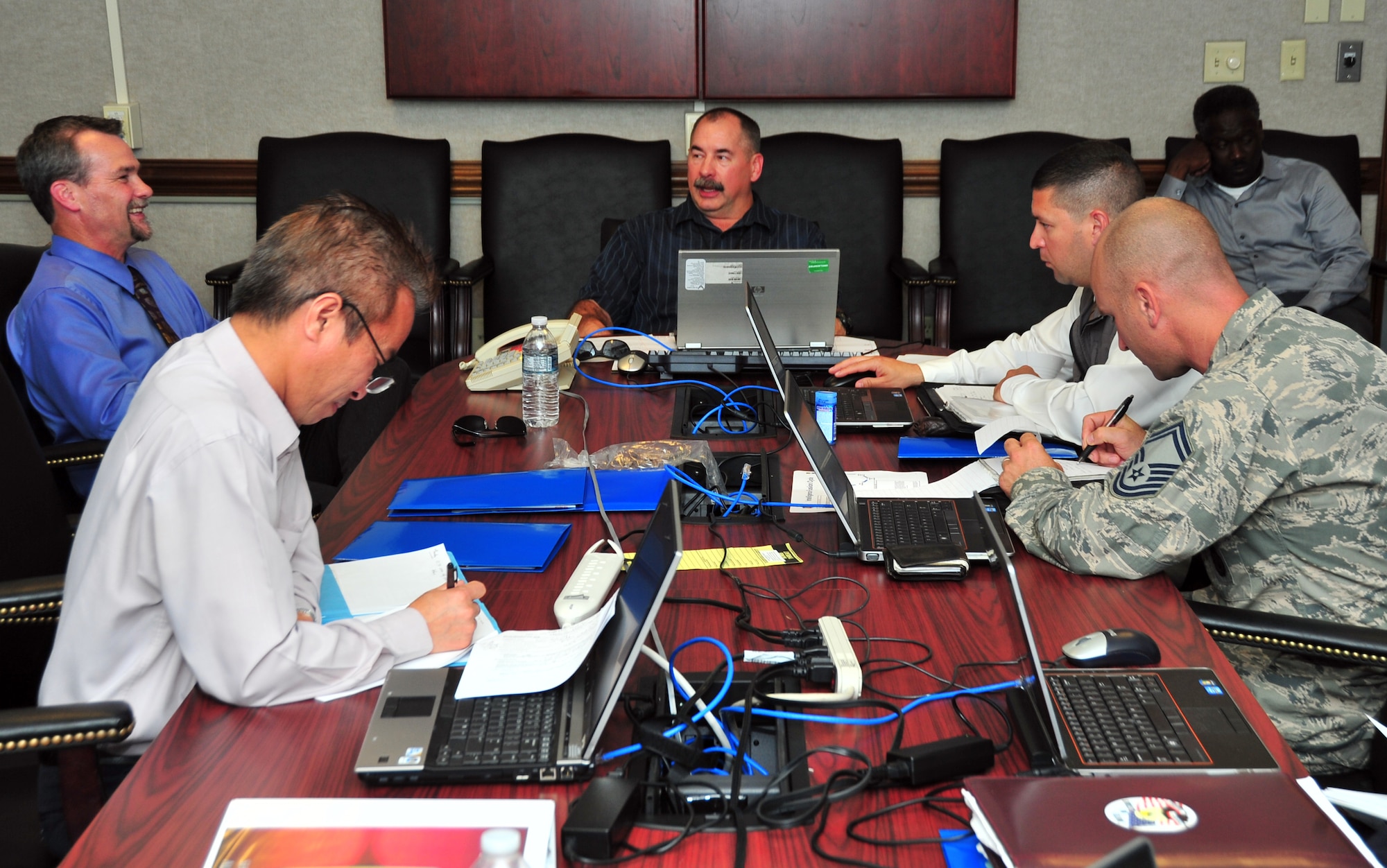 A Headquarters Air Force Security Forces Center team meets for the “hot-wash” at the end of the day April 23 at the 325th Comptrollers Squadron conference room. The HQ AFSFC conducts vulnerability assessments on approximately 20 Air Force installations annually. (U.S. Air Force photo by Airman 1st Class Sergio A. Gamboa)