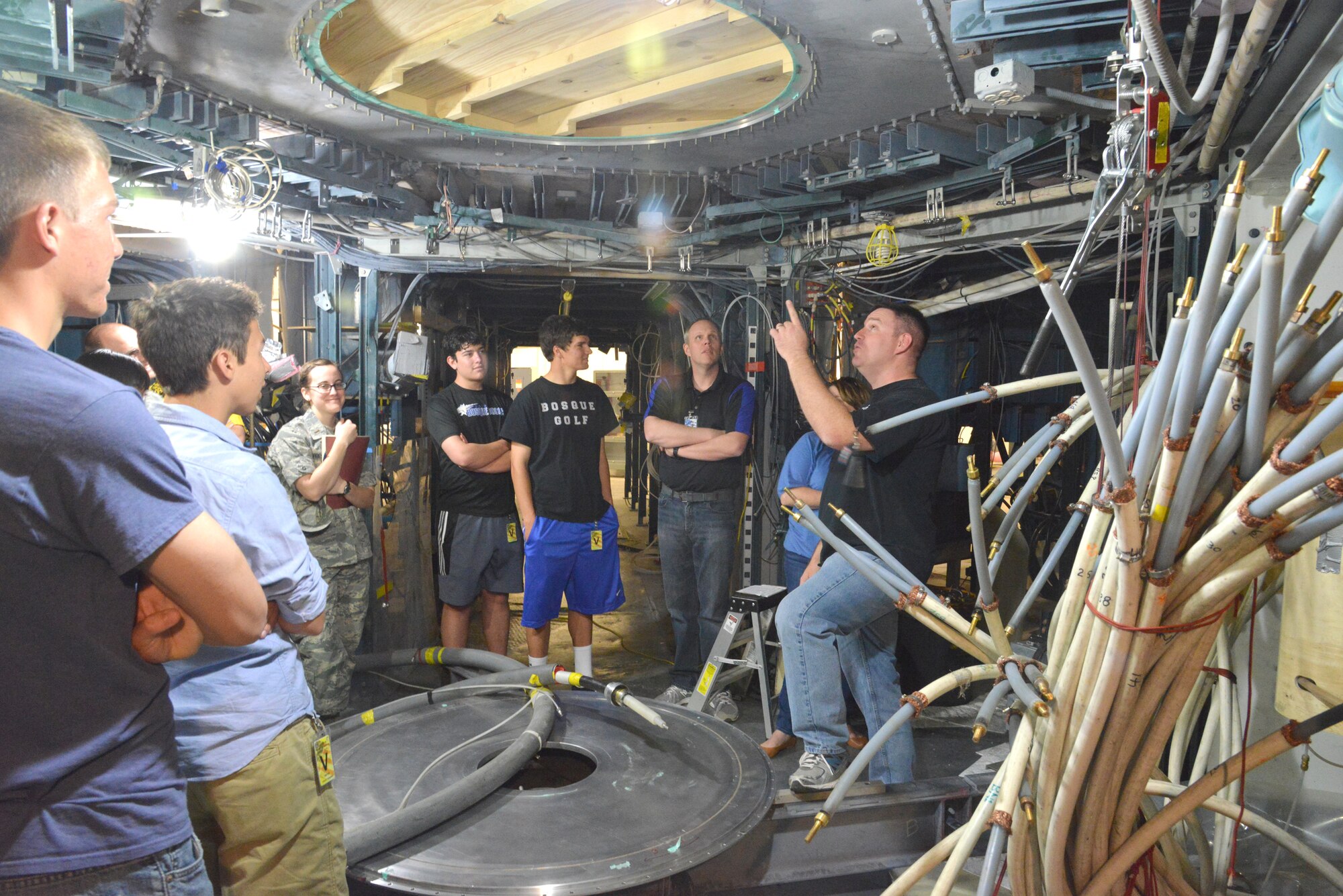 Will White, right, explains the Shiva Star during an Air Force Research Laboratory  tour with students from Bosque School April 11. The Shiva Star, Air Force’s largest pulsed-power system, can produce a pulse of 120,000 volts and 10
million amps in 10 millionths of a second.  (Photo by Ken Moore)