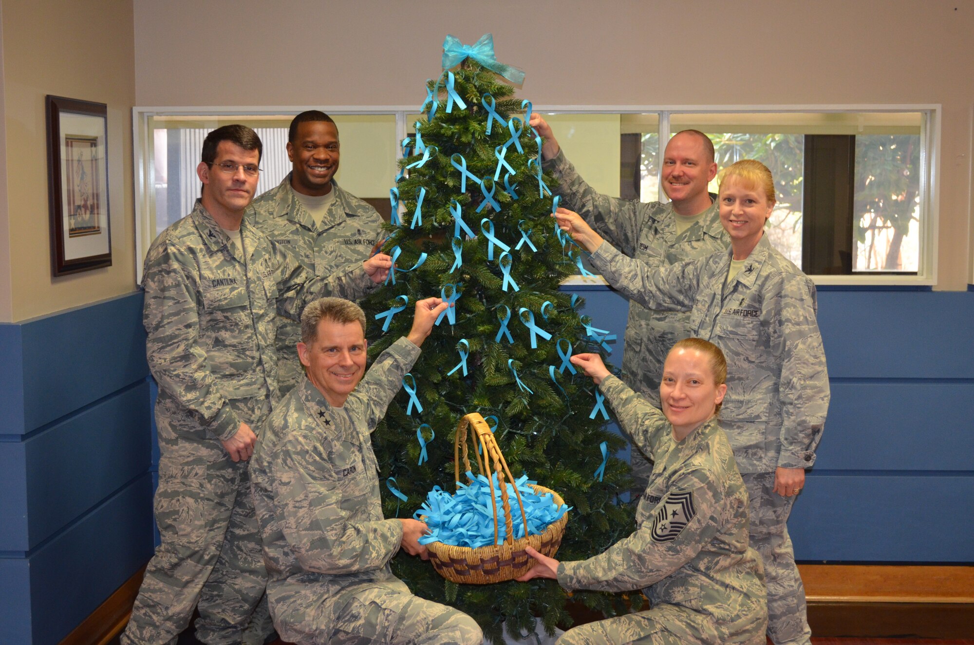 Sexual Assault Awareness Month is recognized every April. Col. Thomas Cantilina, 779 MDG commander; Senior Master Sgt. Tracy Washington; 779 MDG superintendent; Maj. Gen. Gerard Caron, 79 MDW commander; Chief Master Sgt. Michelle Thorsteinson-Richards, 79 MDW command chief; Col. Kathryn Tate, 579 MDG commander; and Senior Master Sgt. Timothy Reim, 579 MDG superintendent place teal ribbons on a tree at Malcolm Grow Medical Clinics and Surgery Center to serve as a statement that they support survivors of sexual assault. They promise to address inappropriate behavior and commit to treating others with dignity and respect. (US Air Force photo/Capt. Kelly Ramey)