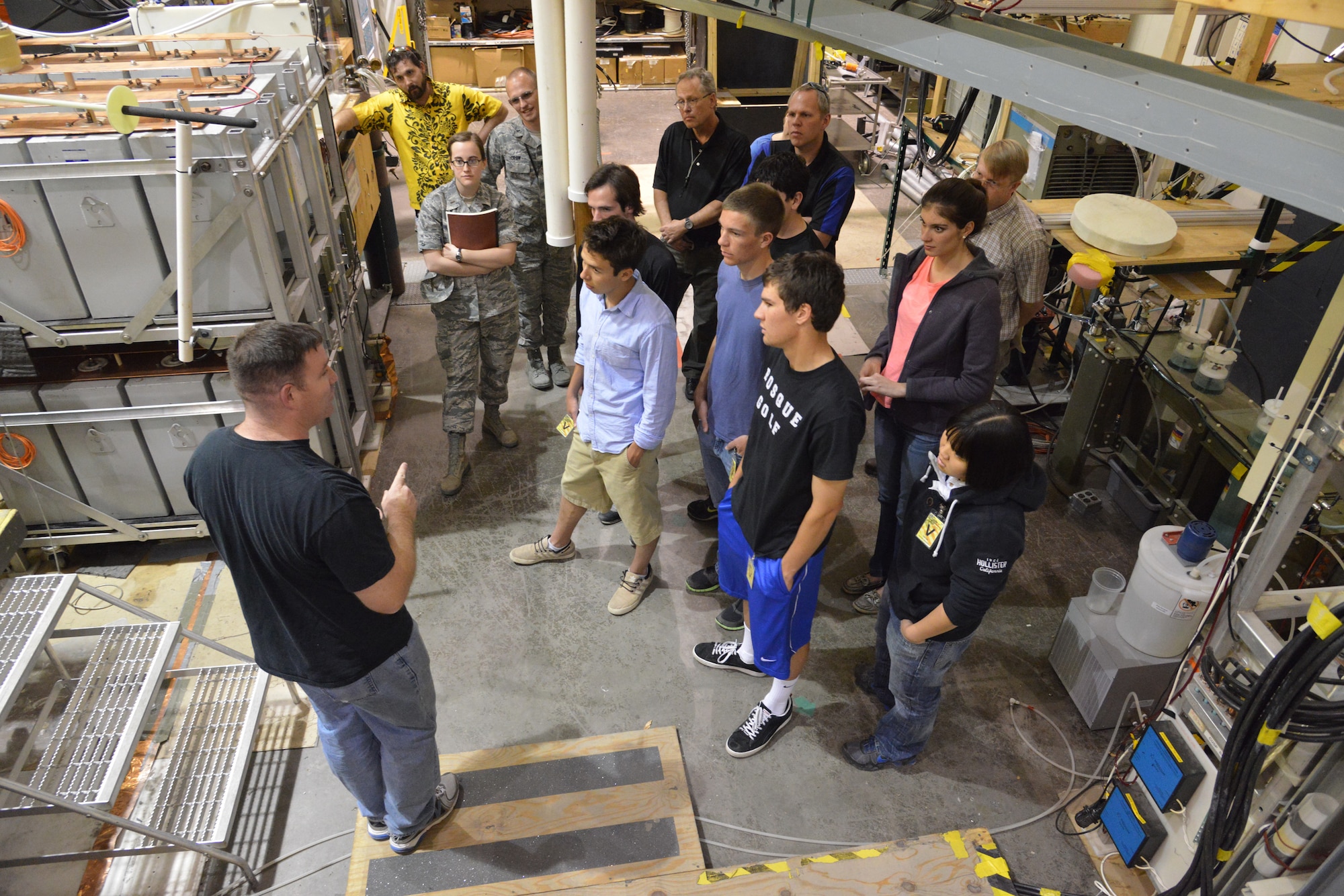 Will White, left, explains the Shiva Star during an Air Force Research Laboratory  tour with students from Bosque School April 11. The Shiva Star, Air Force’s largest pulsed-power system, can produce a pulse of 120,000 volts and 10
million amps in 10 millionths of a second.  (Photo by Ken Moore)