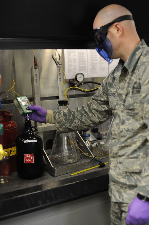 Staff Sgt. David Harris, 87th Logitics Rediness Squadron Fuels Lab NCO in charge, analyzes JP-8 jet fuel Jan. 17, 2014, at Joint Base McGuire-Dix-Lakehurst, N.J. He analyzed the fuel to ensure the amount of dissolved solids in the fuel did not fall outside of acceptable parameters set by Air Force standards for fuel. (U.S. Air Force photo by Airman 1st Class Sean M. Crowe/Released)