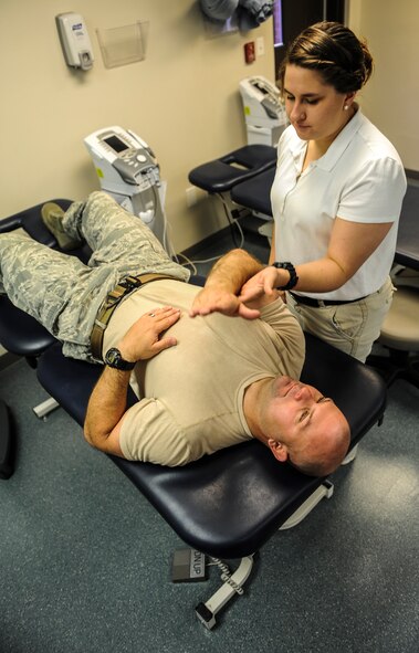 U.S. Air Force Master Sgt. Brandon Livingston, 23d Civil Engineer Squadron explosives ordnance disposal superintendent of logistics, does resistance training with Valdosta State University’s Meghan Trella, senior athletic training student, at Moody Air Force Base, Ga., April 23, 2014. Trella applies force to Livingston’s forearm as he tries to pull her hand down. (Airman 1st Class Alexis Millican/Released)  