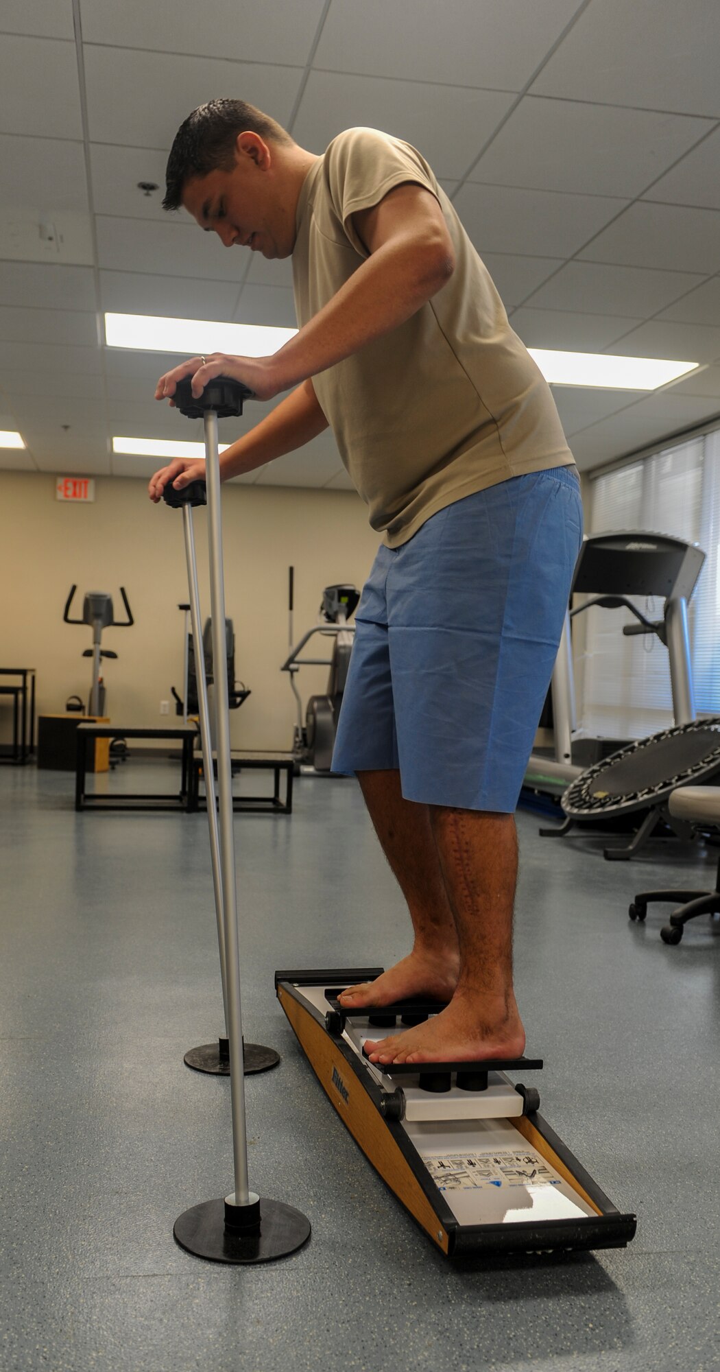 U.S. Air Force Senior Airman Chris Kingsbury, 23d Medical Support Squadron diagnostic imaging technician, controls the movement of a skier device at Moody Air Force Base, Ga., April 23, 2014. The skier device is used to help strengthen muscles in the glutes and hips while helping to regain balance. (Airman 1st Class Alexis Millican/Released) 