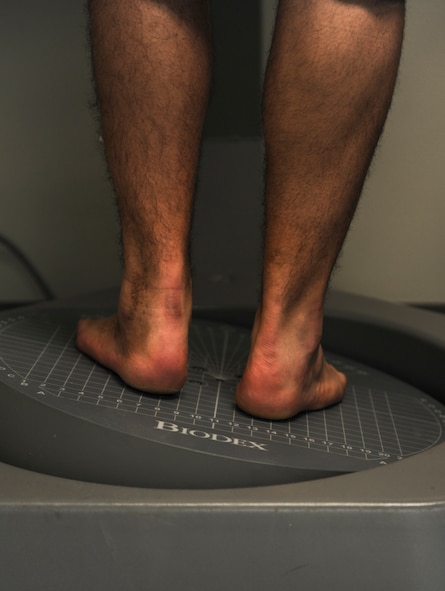U.S. Air Force Senior Airman Chris Kingsbury, 23d Medical Support Squadron diagnostic imaging technician, balances on a balance platform during physical therapy at Moody Air Force Base, Ga., April 23, 2014.  The balance platform helps to re-correct balance issues due to his injuries. (Airman 1st Class Alexis Millican/Released)