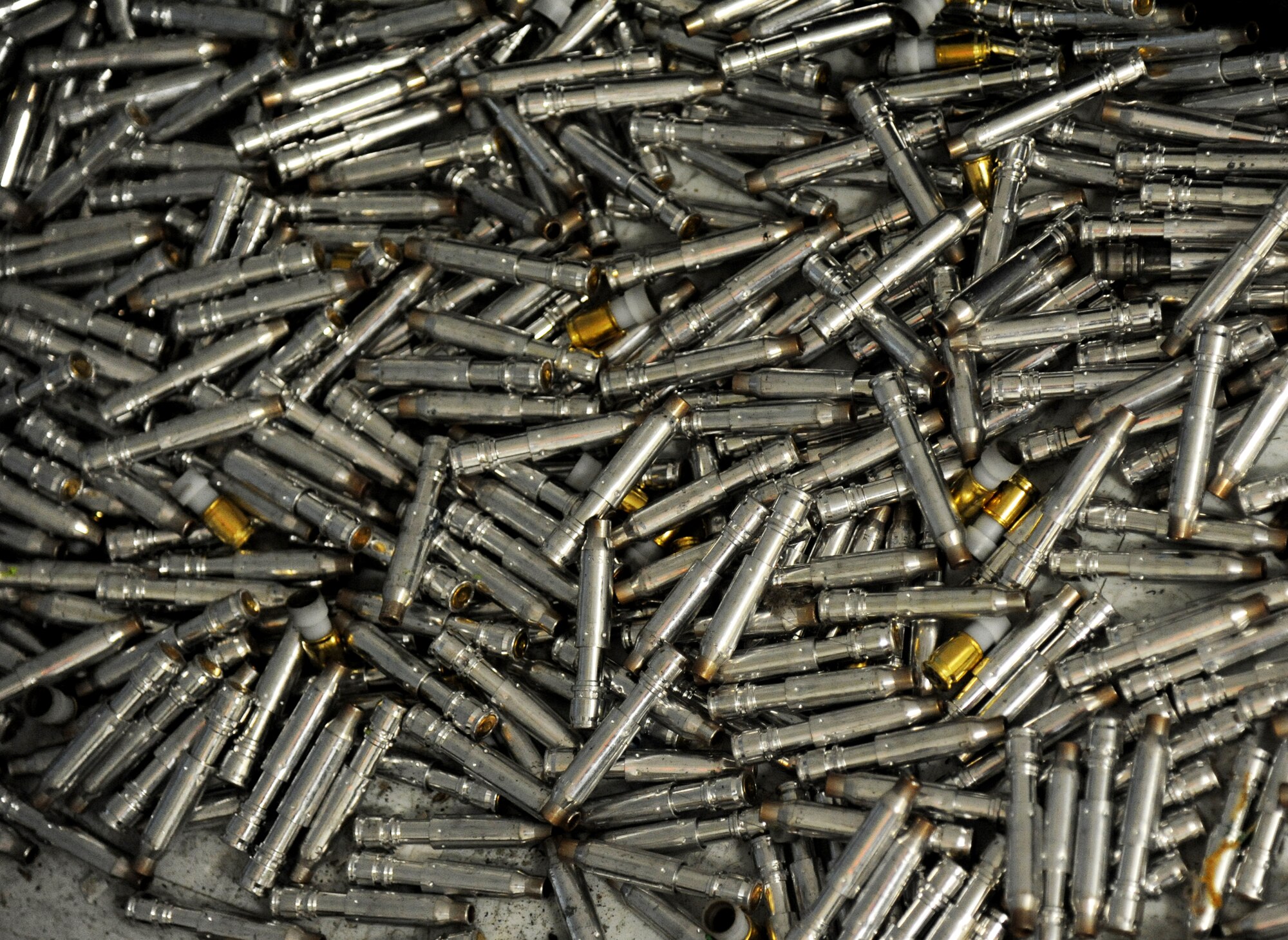 A pile of ammunition gathers on the floor of The Locker House, as members of the 81st Security Forces Squadron go through various scenarios simulating real-world conditions for an 81st SFS active shooter training April 23, 2014, at Keesler Air Force Base, Miss.  The two-day annual training prepares the SF Airmen to react during real-world situations.  (U.S. Air Force photo by Kemberly Groue)