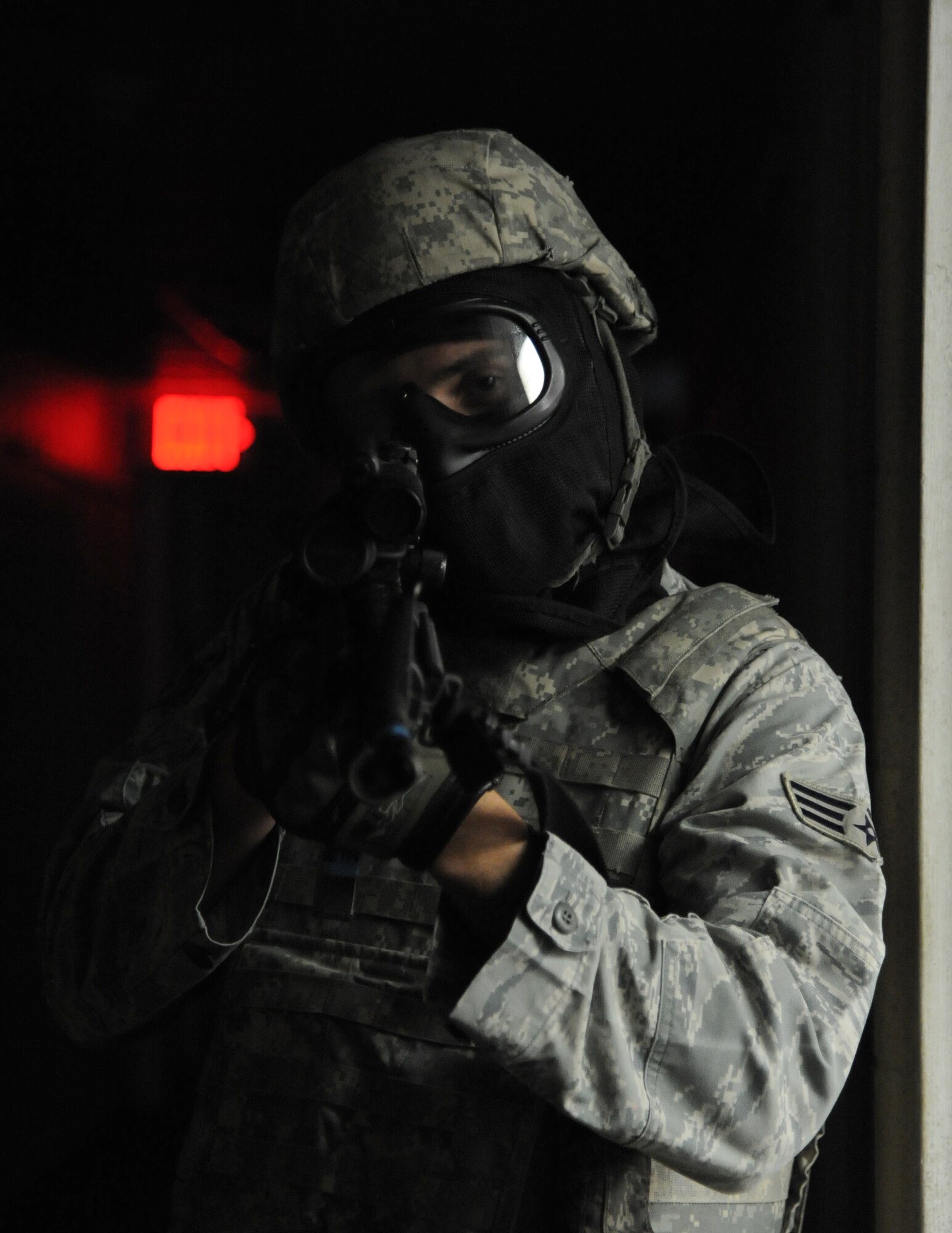 Senior Airman Kenneth Peterman, 81st Security Forces Squadron, secures the hallway during a scenario simulating real world conditions for 81st SFS active shooter training April 23, 2014, at The Locker House, Keesler Air Force Base, Miss.  The two-day annual training prepares the SF Airmen to react during real-world situations.  (U.S. Air Force photo by Kemberly Groue)