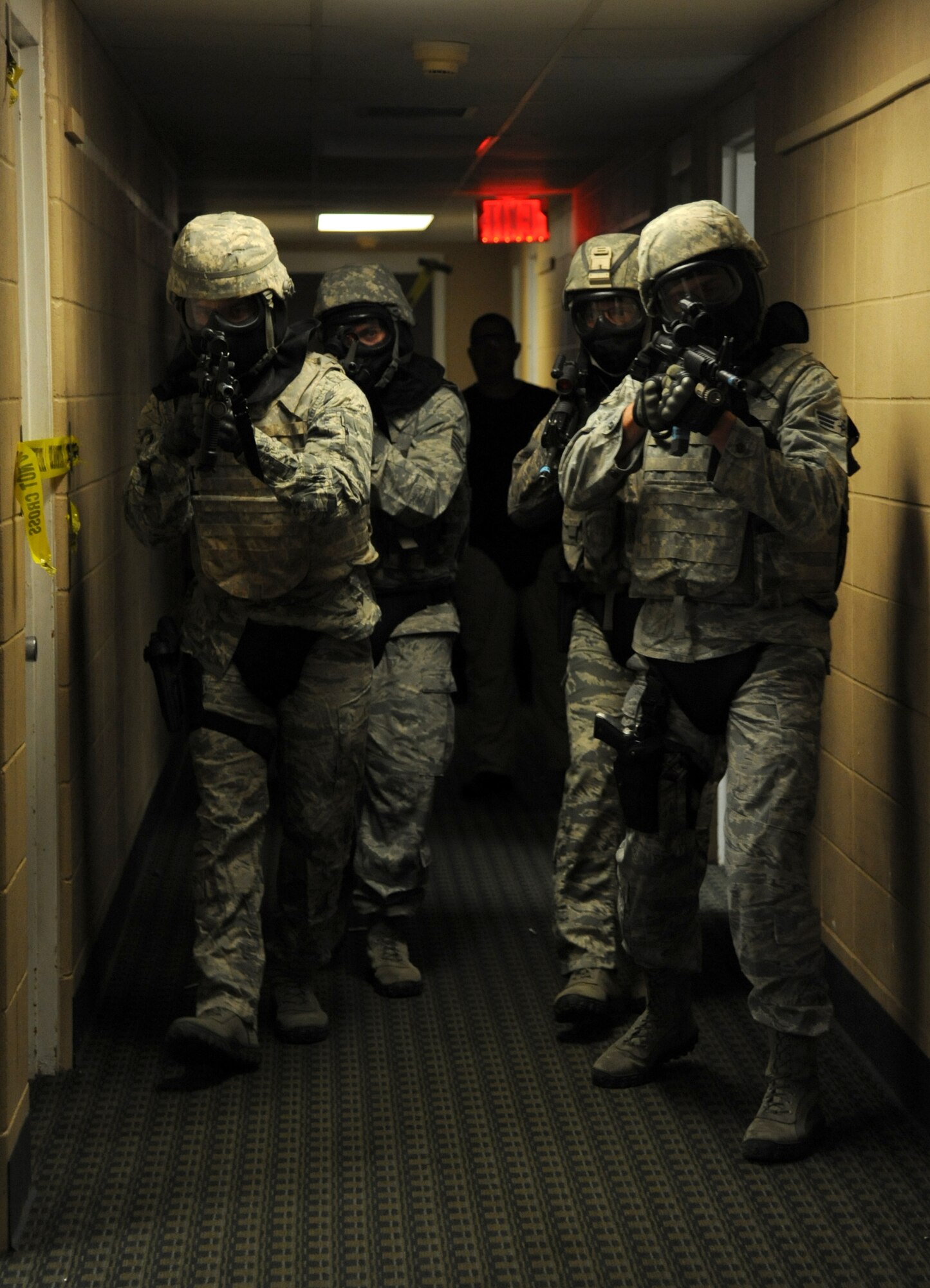 Members of the 81st Security Forces Squadron go through various scenarios simulating real-world conditions for an 81st SFS active shooter training April 23, 2014, at The Locker House, Keesler Air Force Base, Miss.  The two-day annual training prepares the SF Airmen to react during real-world situations.  (U.S. Air Force photo by Kemberly Groue)