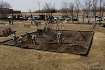 Airmen from the 5th Civil Engineer Squadron spread mulch at a playground during Earth Day on Minot Air Force Base, N.D., April 21, 2014. Airmen from across the base cleaned up base parks, picked up trash and completed other projects to beautify the base and take care of the environment. (U.S. Air Force photo/Senior Airman Malia Jenkins) 