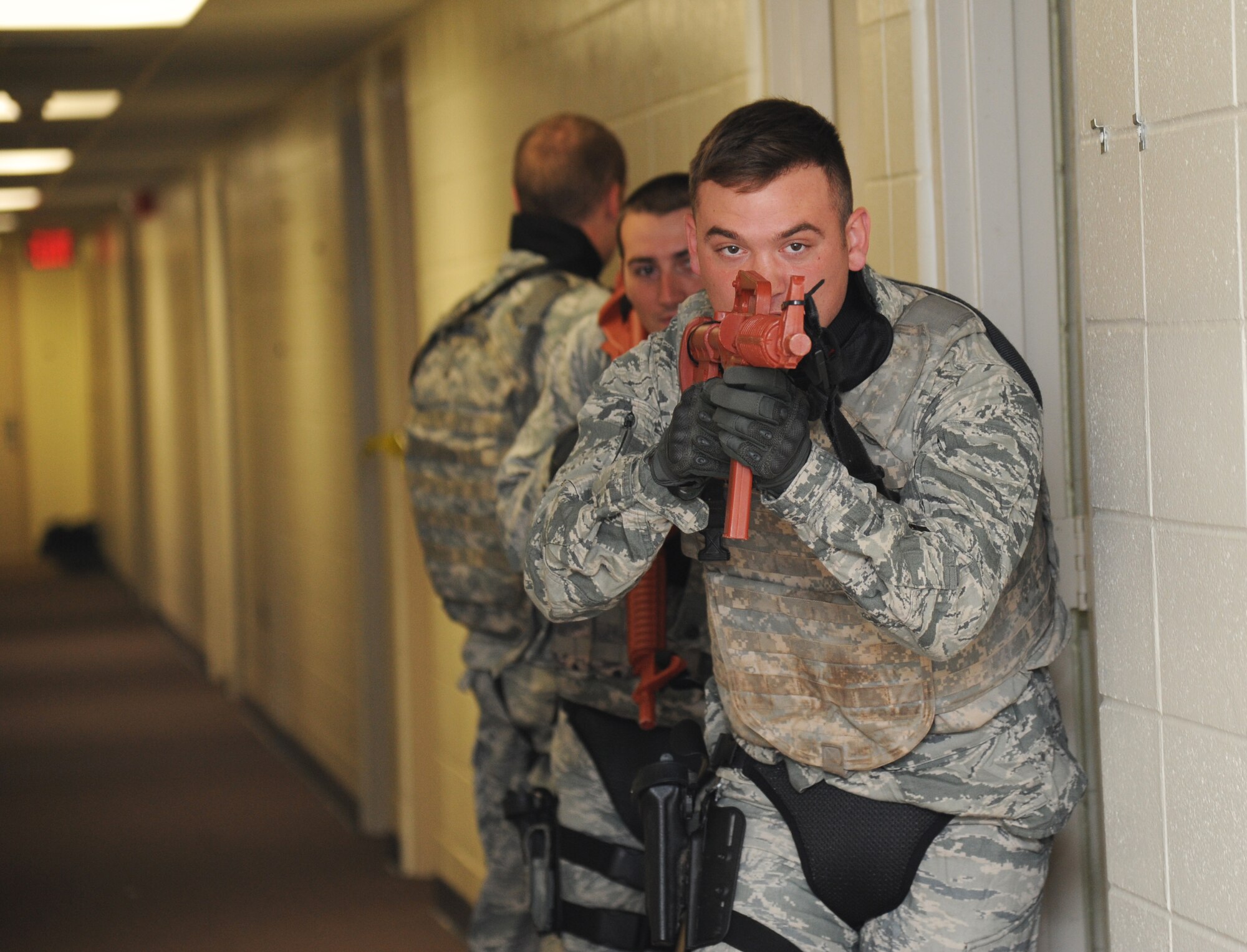 Senior Airman Nicholas Marlow, 81st Security Forces Squadron, leads his team through a scenario during an 81st SFS active shooter training April 23, 2014, at The Locker House, Keesler Air Force Base, Miss.  The two-day annual training prepares the SF Airmen to react during real-world situations.  (U.S. Air Force photo by Kemberly Groue)