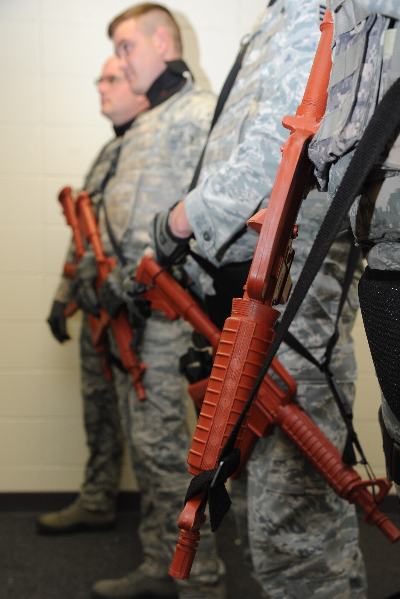 Members of the 81st Security Forces Squadron use simulated weapons while running through various scenarios before transitioning to real weapons during an 81st SFS active shooter training session April 23, 2014, at The Locker House, Keesler Air Force Base, Miss.  The two-day annual training helps prepare the SF Airmen to react during real-world situations.  (U.S. Air Force photo by Kemberly Groue)