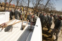 Airmen from the 5th Civil Engineer Squadron grab rakes and shovels to spread mulch during Earth Day at Minot Air Force Base, N.D., April 21, 2014. Airmen from across the base cleaned up base parks, picked up trash and completed other projects to beautify the base and take care of the environment. (U.S. Air Force photo/Senior Airman Malia Jenkins)