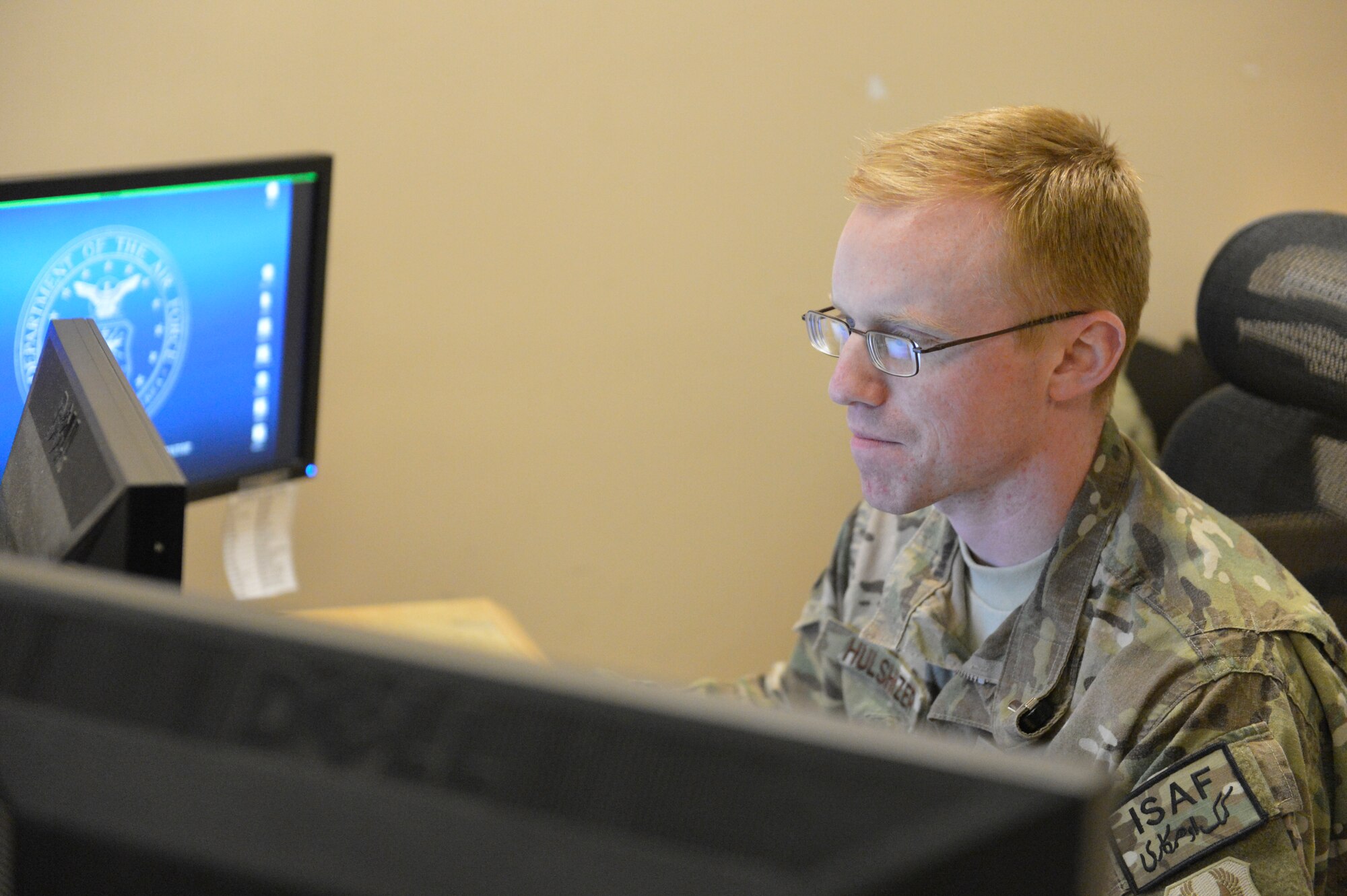 U.S. Air Force Capt. Eric Hulshizer reviews budget numbers at the 455th Expeditionary Finance Office, Bagram Airfield, Afghanistan, April 23, 2014. Hulshizer, a native of Edmond, Okla., and deployed out of Robins Air Force Base, is the finance officer at Bagram.(U.S. Air Force photo by Senior Master Sgt. Gary J. Rihn/Released)