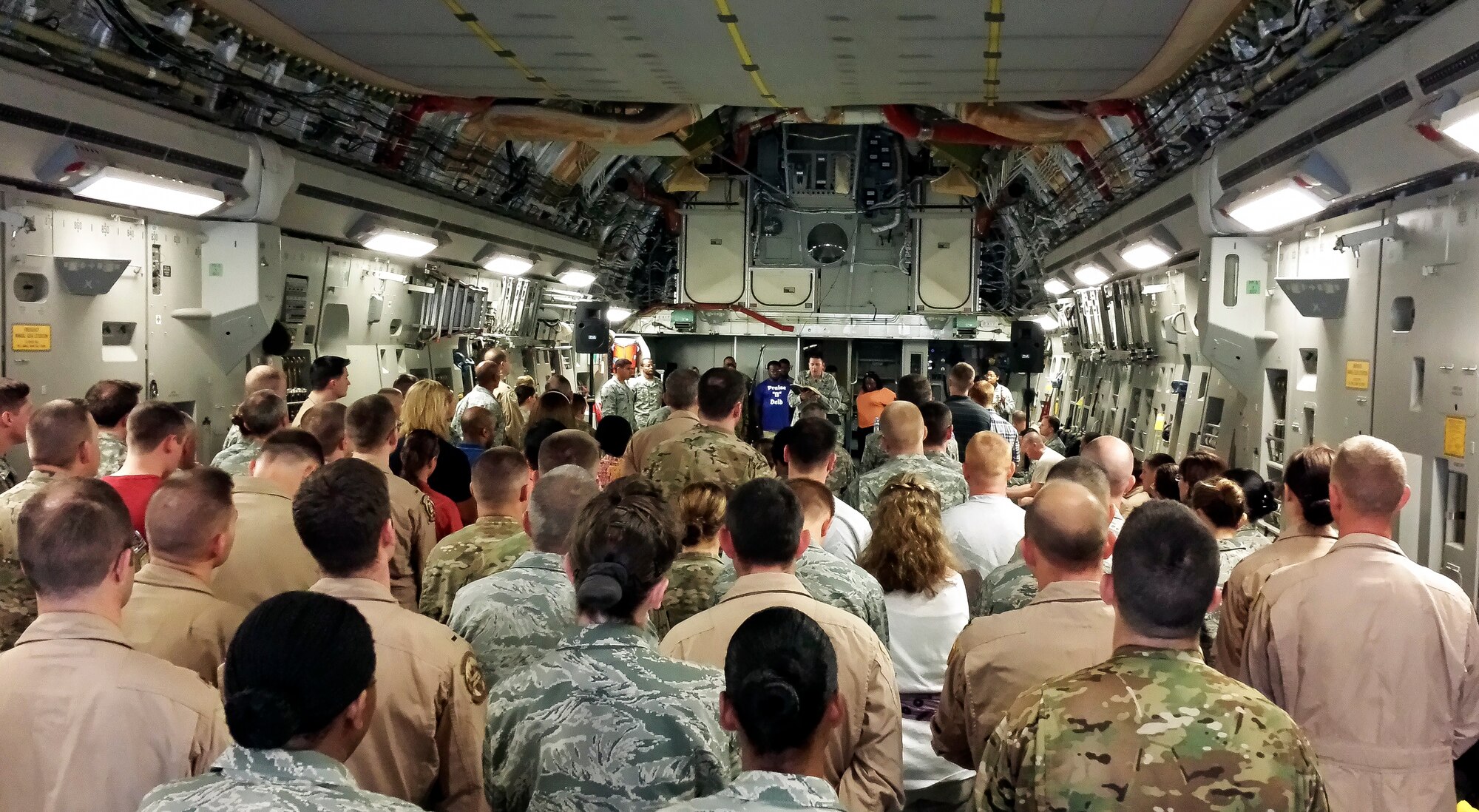 More than 200 Airmen, Sailors, Soldiers, Marines and civilians aboard a C-17 Globemaster III listen to Chaplain (Capt.) Shane Moore’s sermon during an Easter Sunday service, at Al Udeid Air Base, Qatar, April 20, 2014. Moore is the 379th Expeditionary Operations Group chaplain who is deployed from Shepard Air Force Base, Texas.  (Courtesy photo) 
