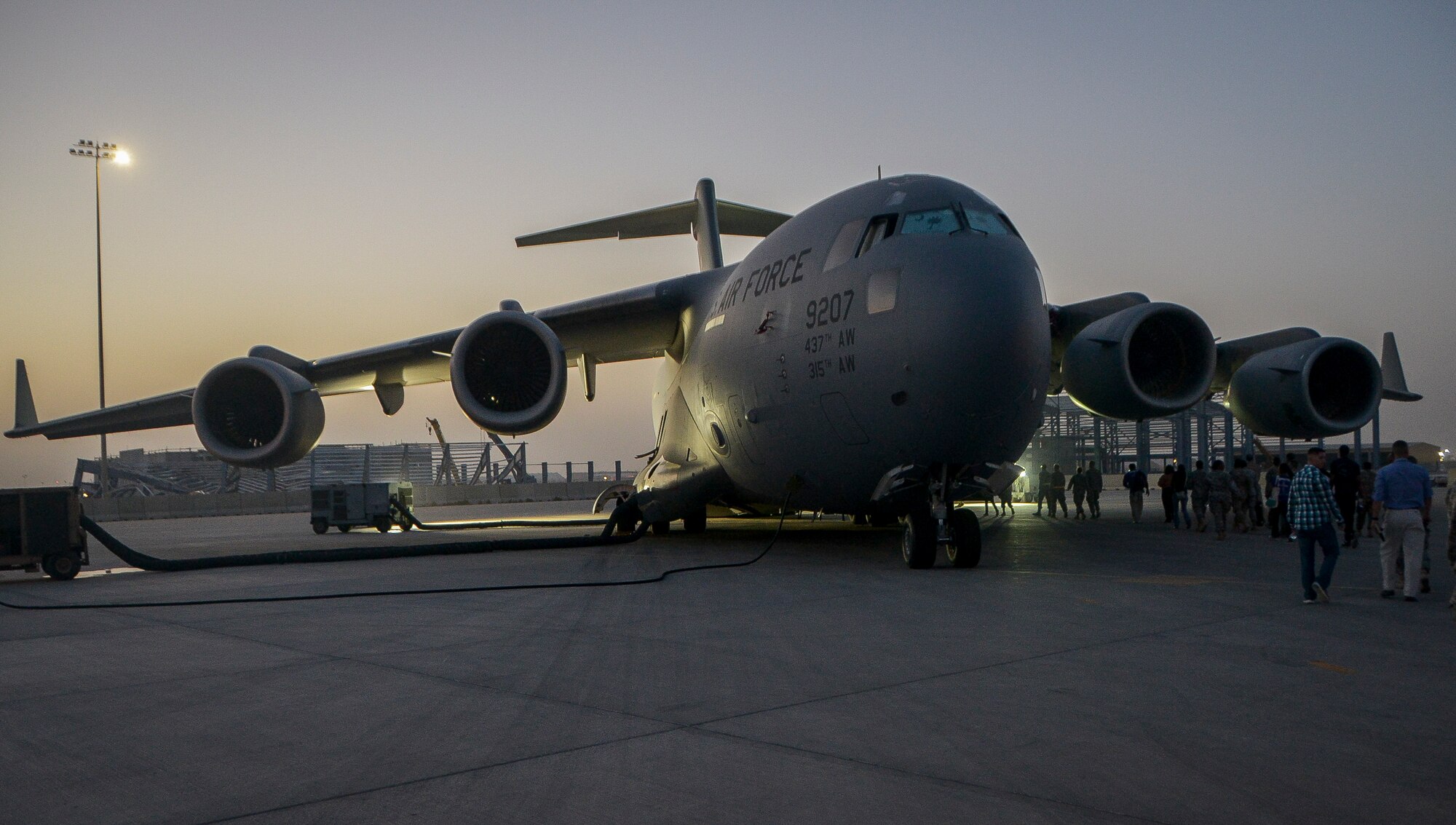 More than 200 Airmen, Sailors, Soldiers, Marines and civilians board a C-17 Globemaster III during an Easter Sunday service, at Al Udeid Air Base, Qatar, April 20, 2014. (U.S. Air Force photo/Senior Airman Jared Trimarchi) 