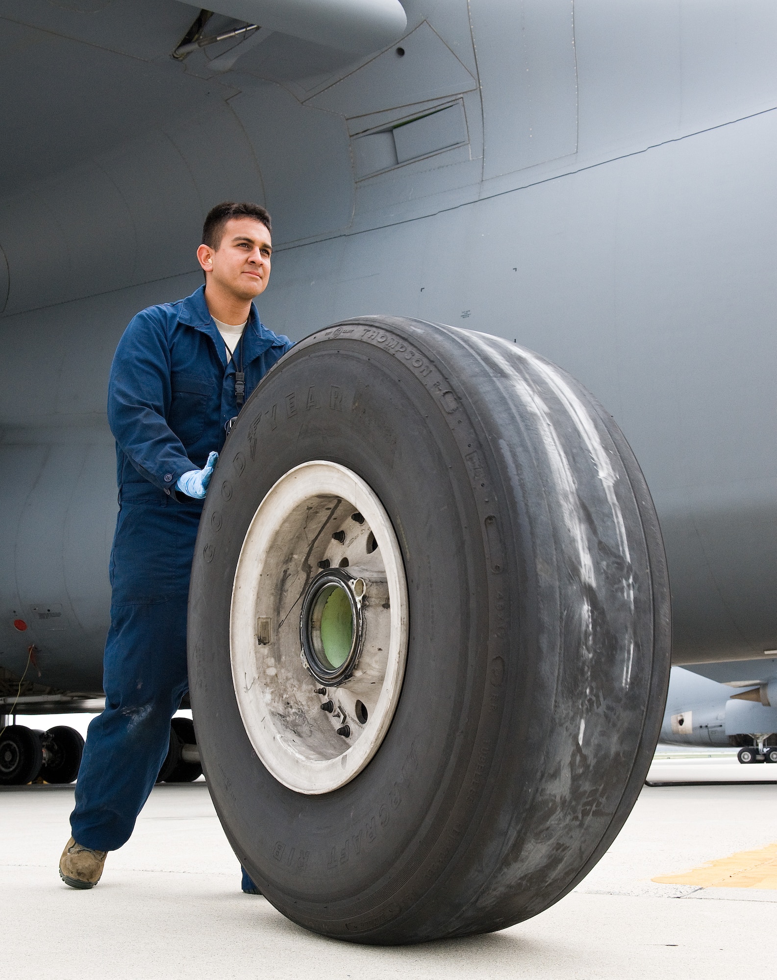 Airman 1st Class Vincent Gaspara, 436th Aircraft Maintenance Squadron crew chief, rolls a defective C-5M Super Galaxy main landing gear wheel and tire assembly April 22, 2014, at Dover Air Force Base, Del. Gaspara placed the defective wheel and tire assembly on a trailer to be taken to the wheel and tire shop for breakdown, rebuild and inspection. (U.S. Air Force photo by Roland Balik)