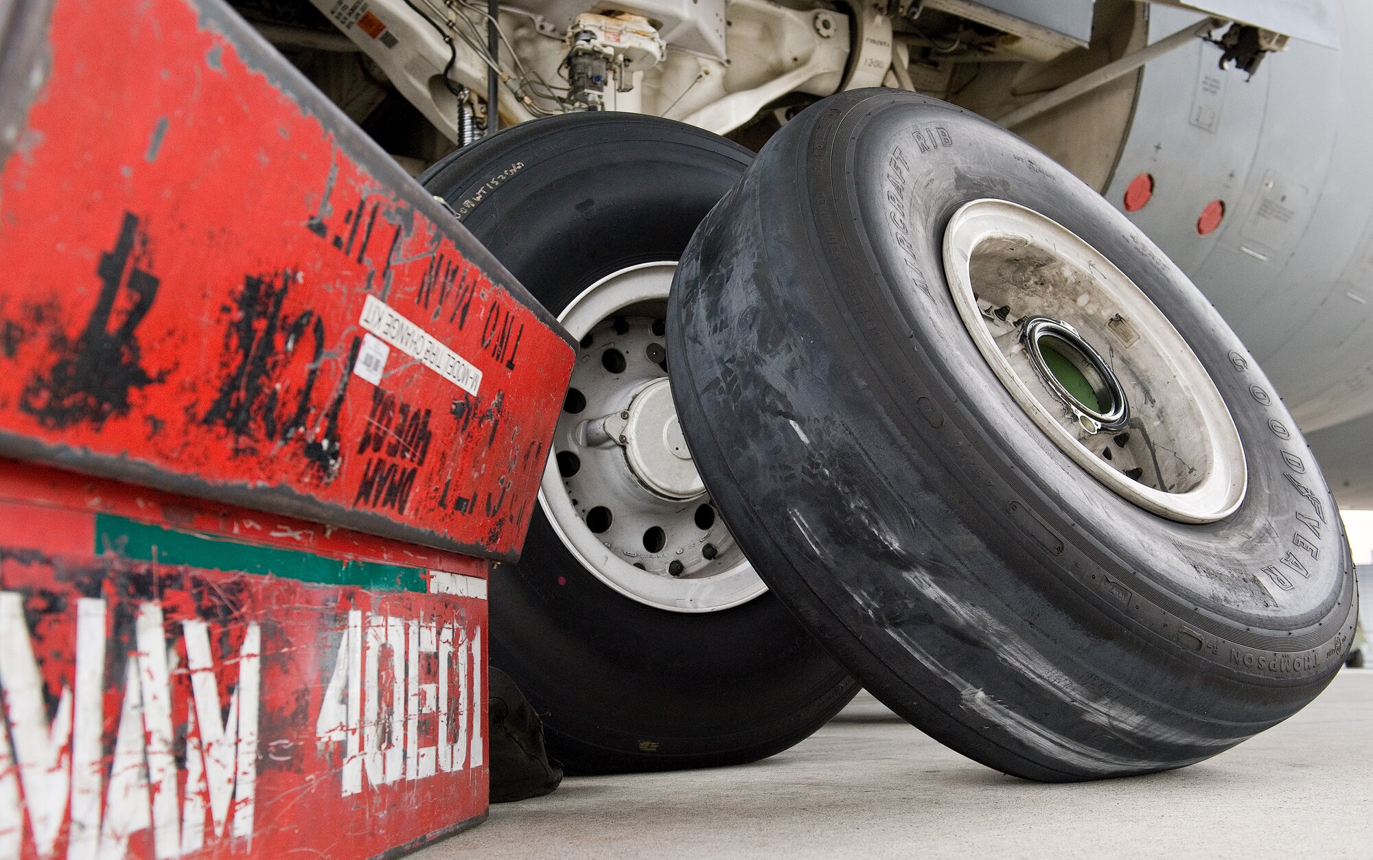A defective C-5M Super Galaxy main landing gear wheel and tire assembly prior to being taken away for maintenance April 22, 2014, at Dover Air Force Base, Del. The 4A1 tire was required to be changed due to tread wear exceeding limits specified in the technical order. Crew chiefs use chalk to identify possible tread wear that is out of limits. (U.S. Air Force photo by Roland Balik)