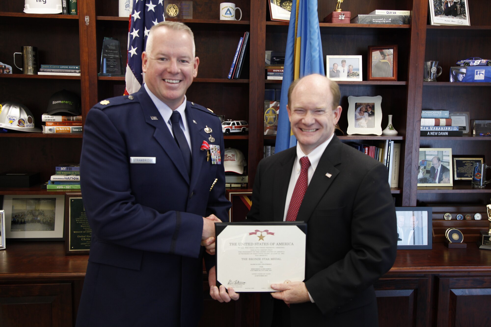 Maj David Strawbridge, Air Force Special Operations Command reserve intelligence officer, was presented the Bronze Star Medal for his service in Afghanistan by U.S. Sen. Chris Coons of Delaware, April 17. 