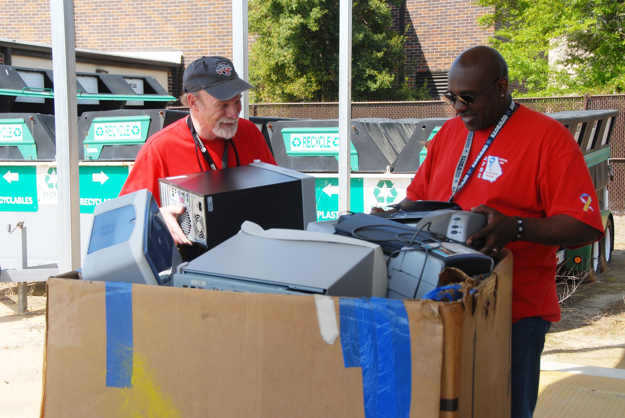 Randy Stillwell, Qualified Recycling Program manager (left) and QRP operations manager Darryl Mercer, get set to weigh equipment during record-breaking E-Cycling event, April 11.  (U.S. Air Force photo by Misuzu Allen)
